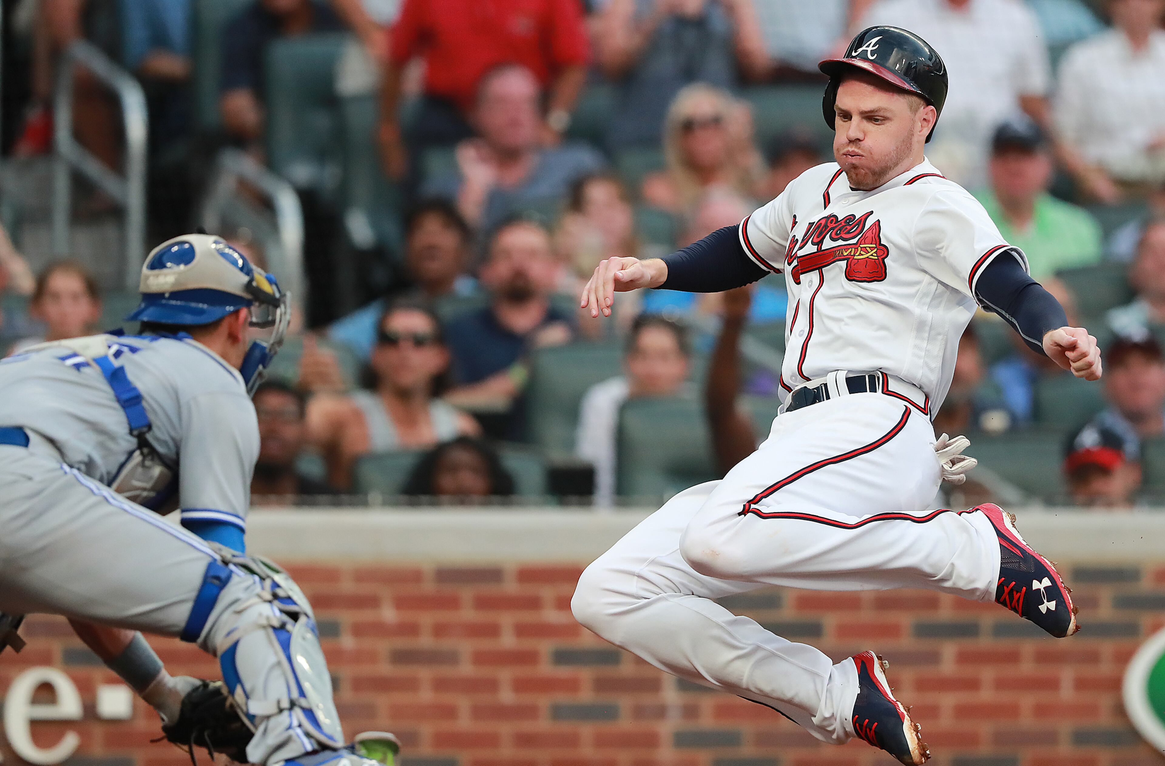 July 11, 2018 Atlanta: Atlanta Braves Freddie Freeman scores past Toronto Blue Jays catcher Luke Maile on a Nick Markakis RBI double to take a 5-0 lead during the second inning in a MLB baseball game on Wednesday, July 11, 2018, in Atlanta. Curtis Compton/ccompton@ajc.com