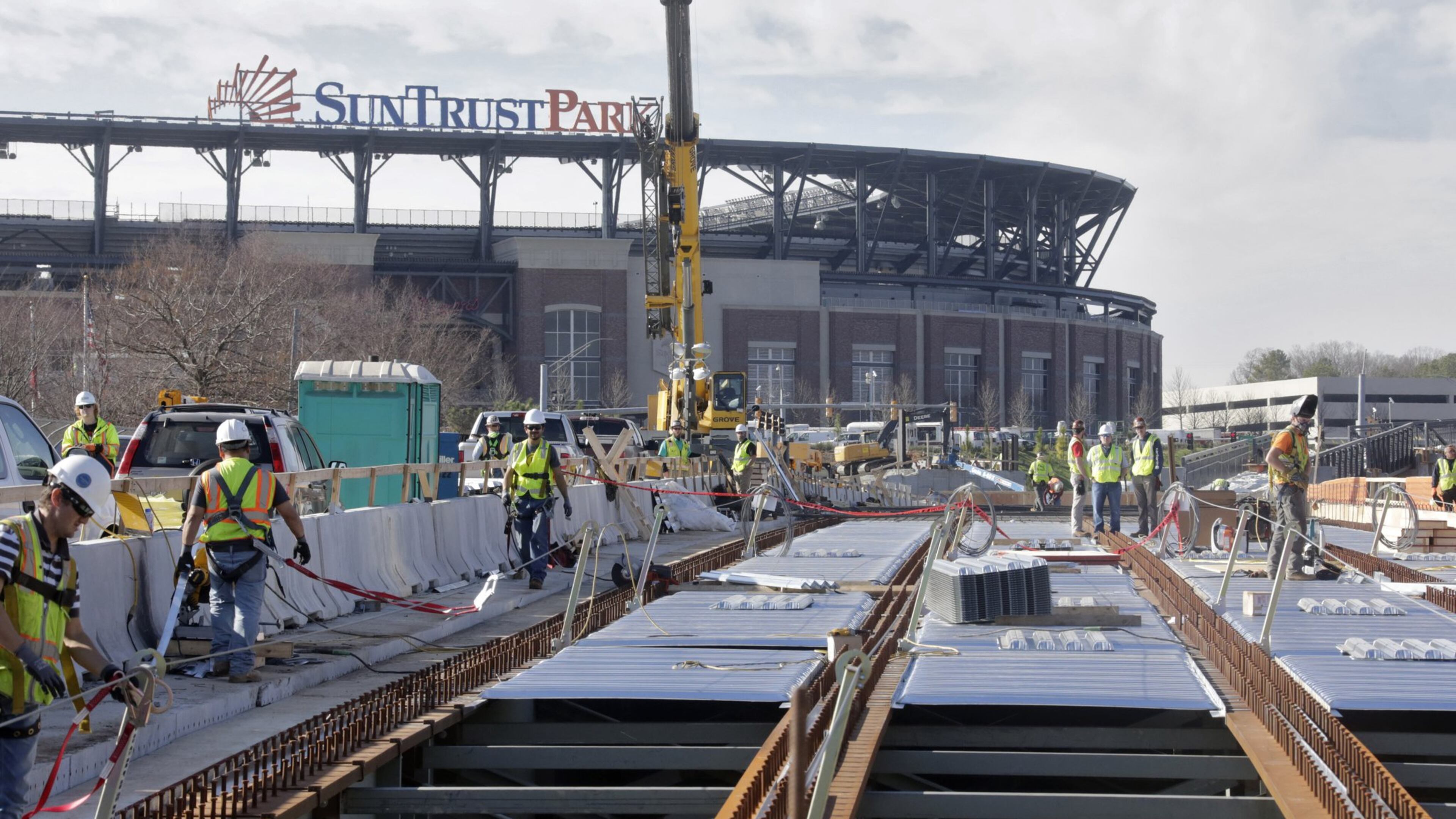 The elevated walkway over Windy Ridge Parkway to SunTrust Park is under construction and is one of the projects for which the Braves are seeking reimbursement from Cobb taxpayers. There is an on-going dispute between the county and Braves as to whether taxpayers are responsible for roads, bridges and other pedestrian improvements in and around the SunTrust Park development. BOB ANDRES /BANDRES@AJC.COM