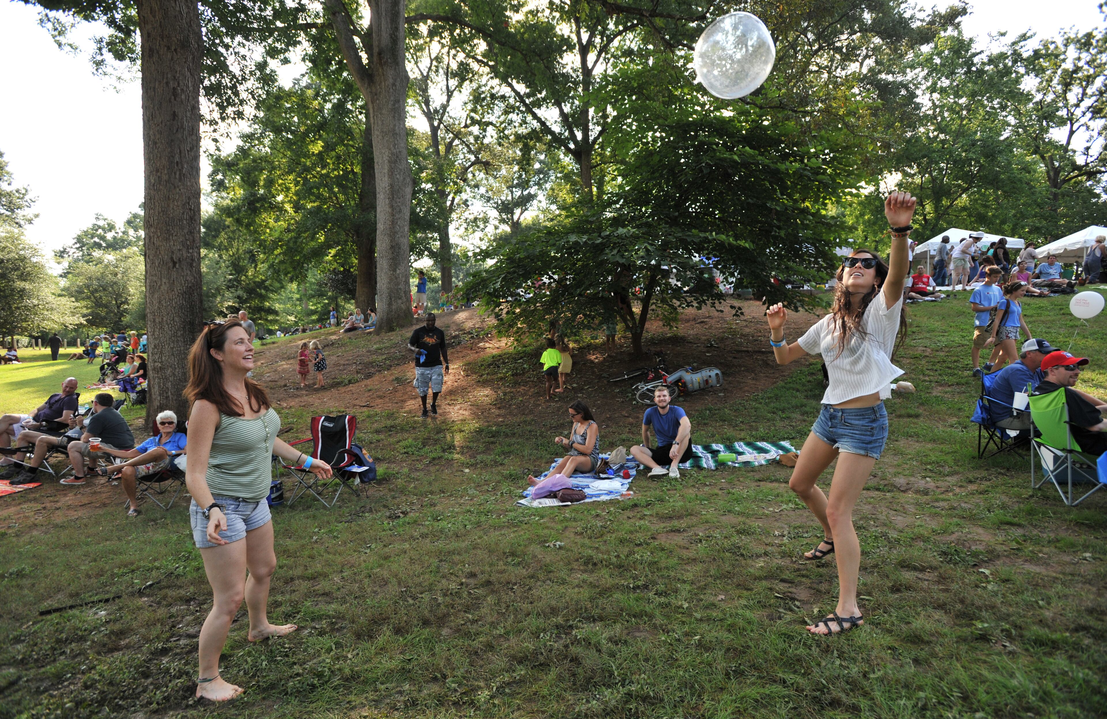Emma Goldberg (left) and Melissa Keightley, both of Atlanta, play volleyball during Grant Park Summer Shade Festival on Saturday, August 24, 2013. The Grant Park Summer Shade Festival features an artist market, children's activities, great food, live music and the Adams Realtors 5K Run for the Park. The Children's Fun Center is a family favorite with storytellers, jugglers, sing-a-longs and kid-sized make-and-take projects. HYOSUB SHIN / HSHIN@AJC.COM