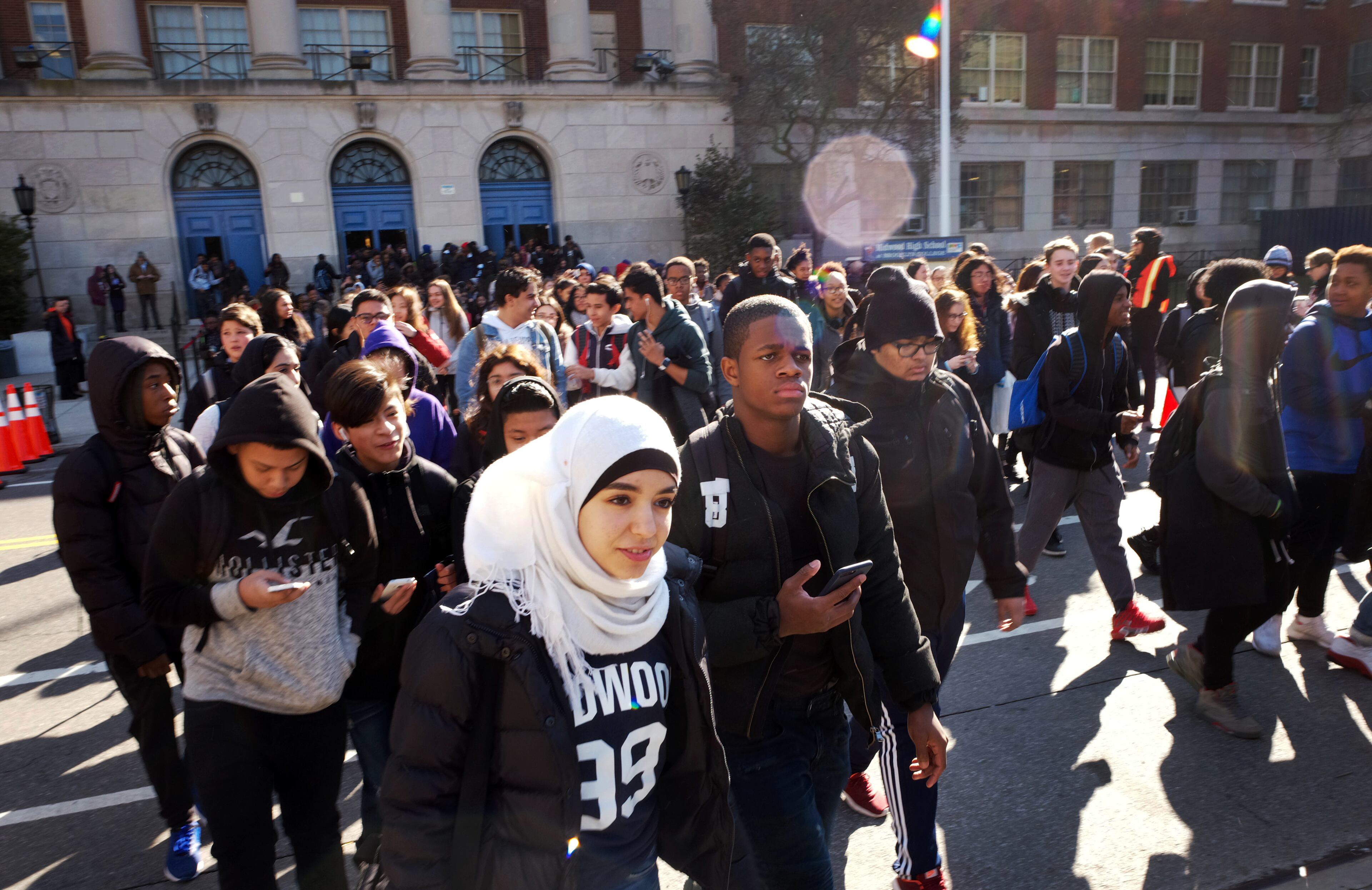 Hundreds of students walk out of Midwood High School as part of a nationwide protest against gun violence, Wednesday, March 14, 2018, in the Brooklyn borough of New York. It is the nation's biggest demonstration yet of the student activism that has emerged in response to last month's massacre of 17 people at Florida's Marjory Stoneman Douglas High School. (AP Photo/Mark Lennihan)