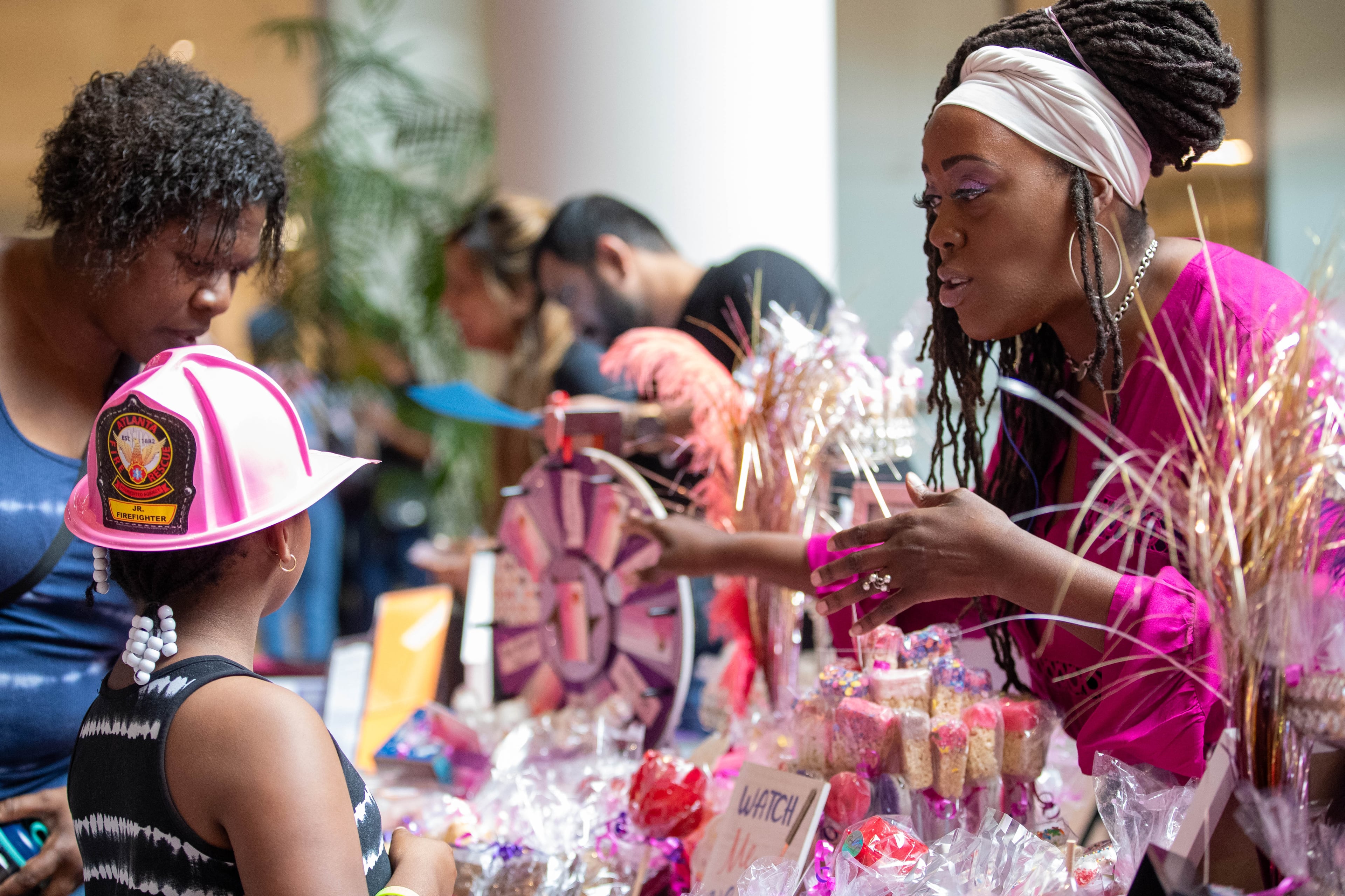 Jaynine Taylor gives away free sweets to children at the 20th annual Back-to-School Bash at Greenbriar Mall in Atlanta on Saturday, July 22, 2023. (Katelyn Myrick/katelyn.myrick@ajc.com)