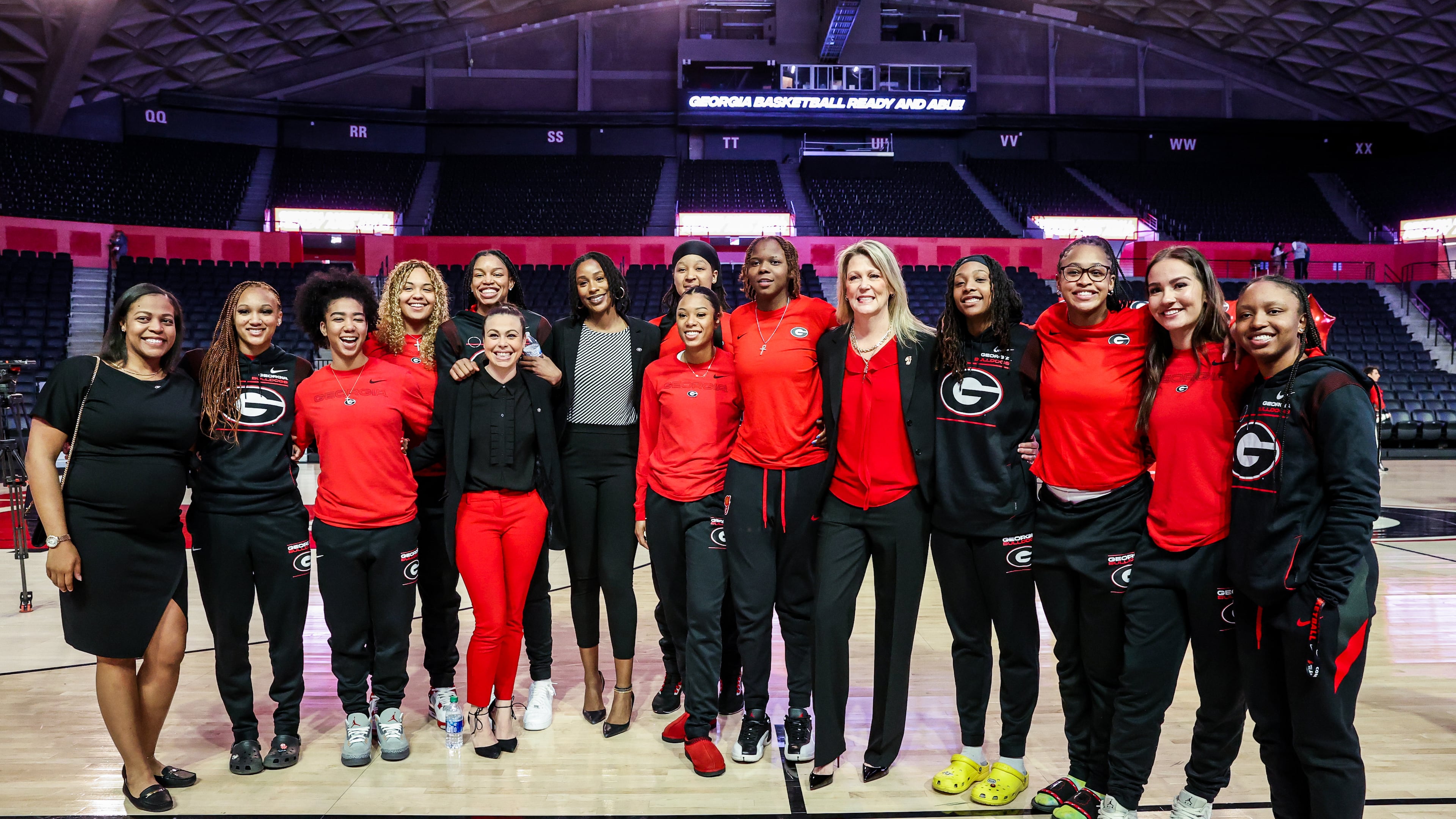 Georgia coach Katie Abrahamson-Henderson takes a photo with members of her Lady Bulldogs team after she was introduced as the head coach Tuesday at Stegeman Coliseum. (Photo by Tony Walsh)