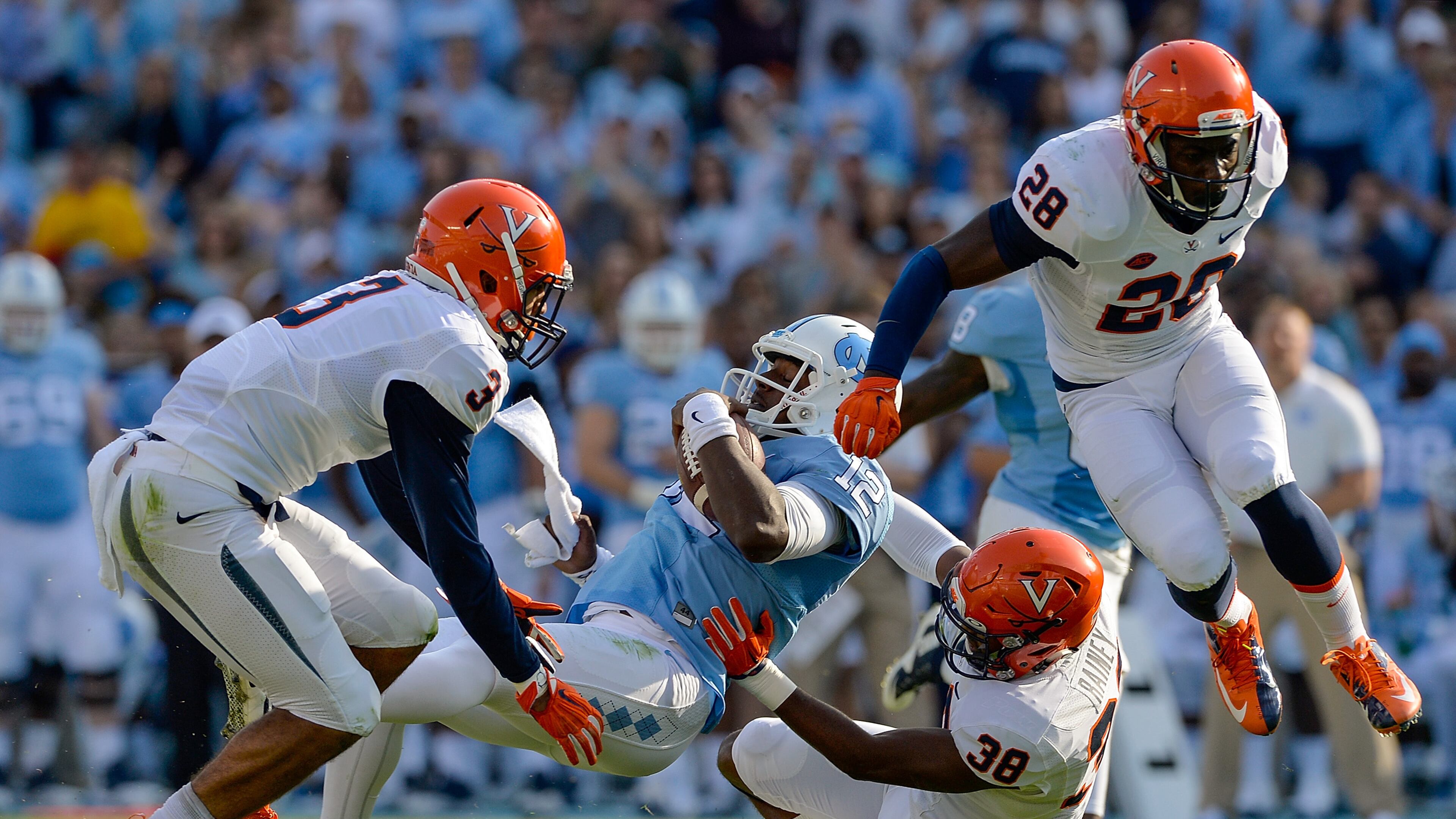 CHAPEL HILL, NC - OCTOBER 24: Quin Blanding #3 and Kelvin Rainey #38 of the Virginia Cavaliers tackle Marquise Williams #12 of the North Carolina Tar Heels during their game at Kenan Stadium on October 24, 2015 in Chapel Hill, North Carolina. (Photo by Grant Halverson/Getty Images)