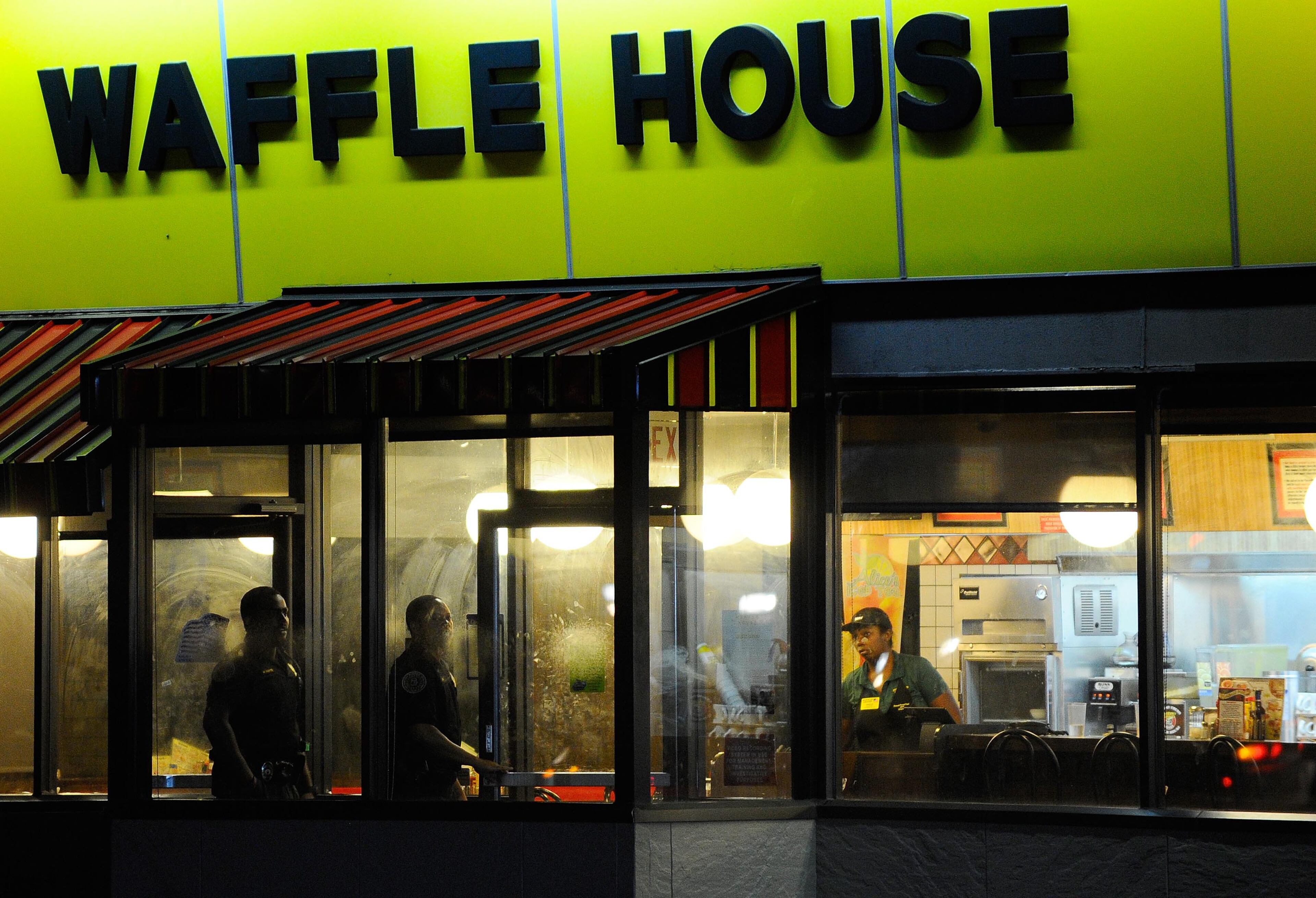 Norcross police and the GBI investigate an officer-involved shooting at the Fusion Event Hall parking lot next to a Knights Inn motel and the adjacent Waffle House at Indian Trail Road and Brook Hollow Parkway on Monday, Oct. 13, 2014, in Norcross, Ga.