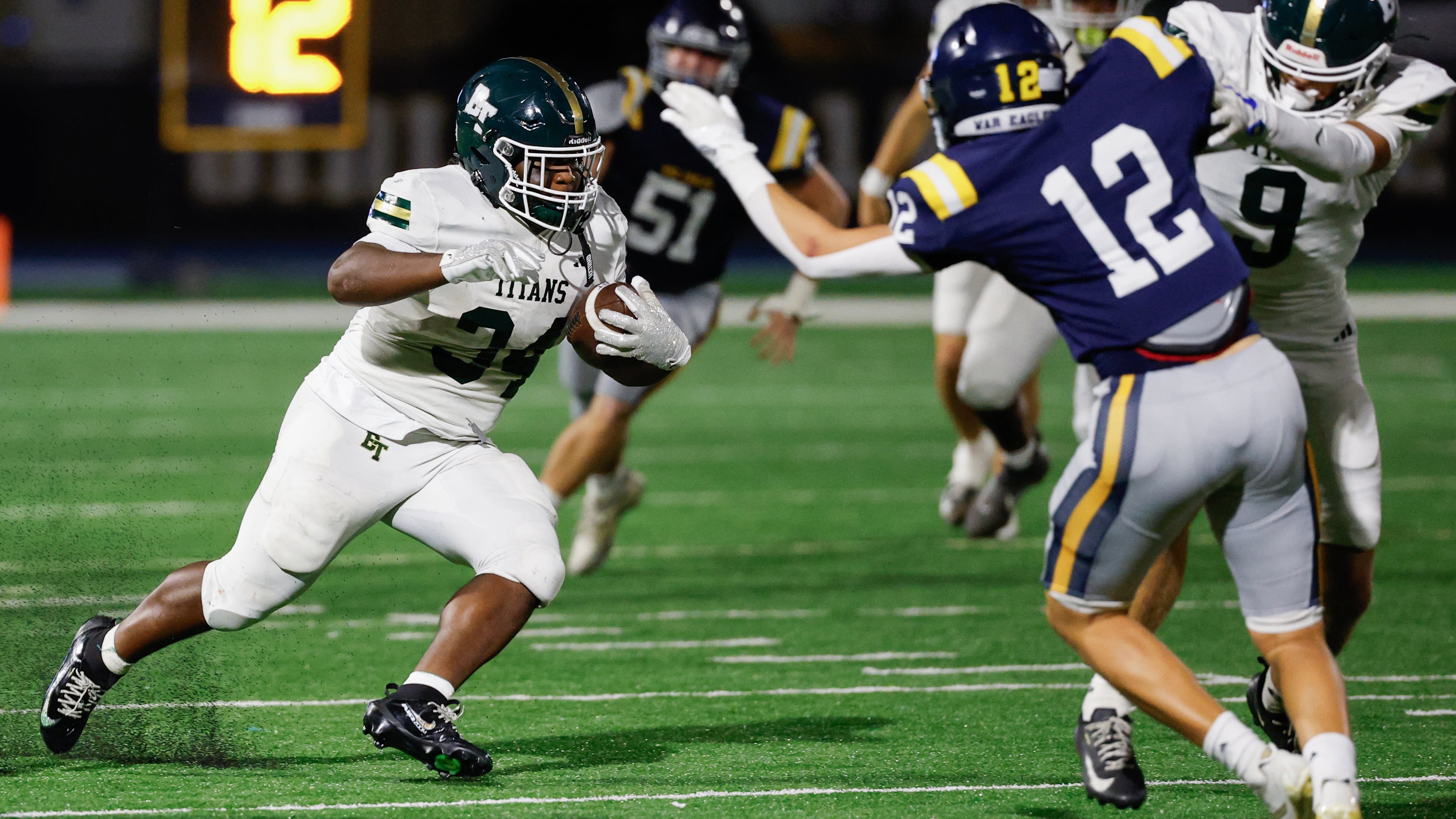 Blessed Trinity's MJ Craft (34) runs against Marist's Bobby Harpring (12) during the first half a high school football game between Blessed Trinity and Marist, Friday, Sept. 25, 2026, in Atlanta. (Erik S. Lesser for the AJC)
