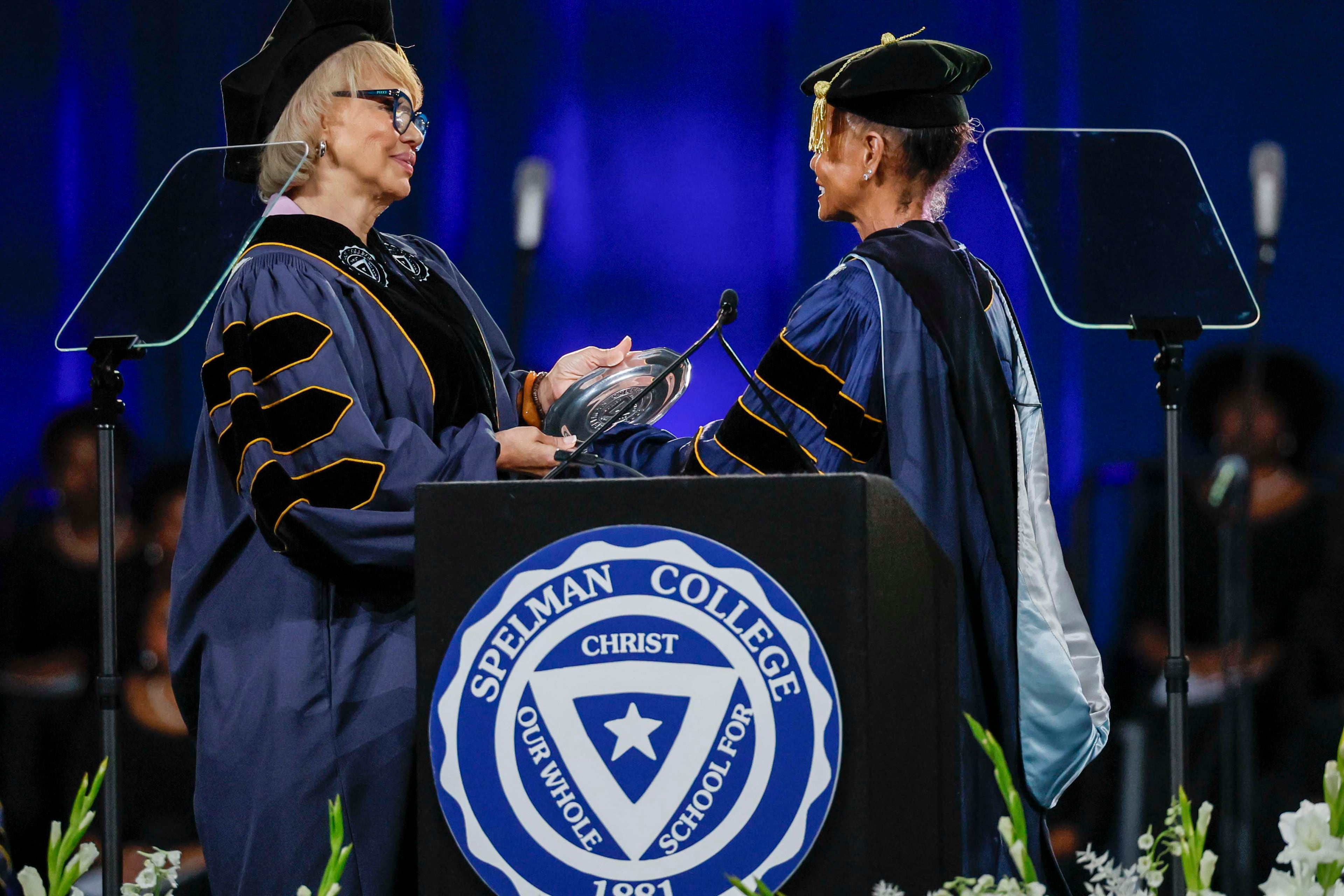 Claire Babineaux-Fontenot, left, is presented with the National Community Service Award during the Spelman College Commencement ceremony at the Georgia International Convention Center in College Park on Sunday, May 17, 2026. (Miguel Martinez/AJC)