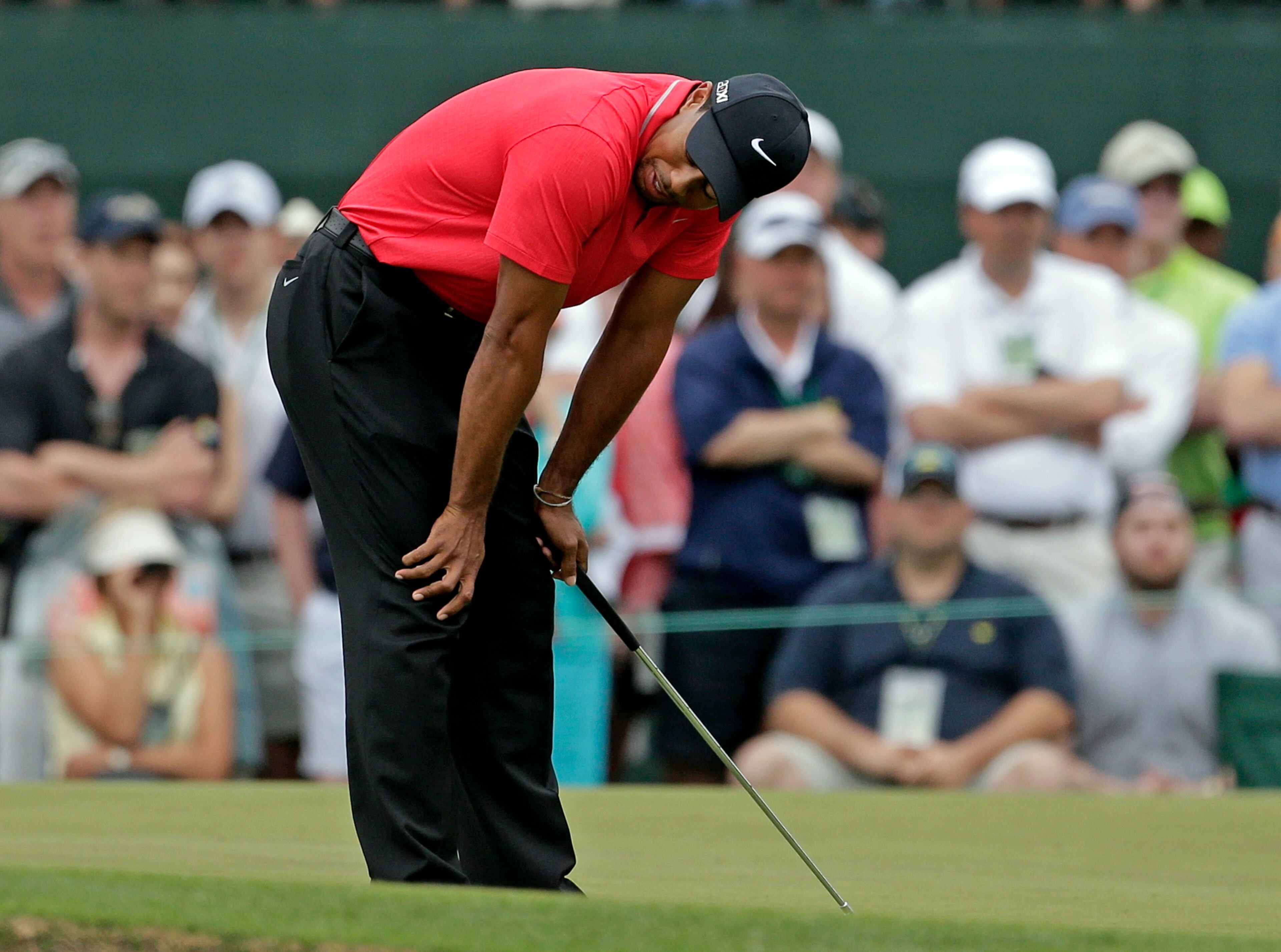 Tiger Woods reacts after missing a birdie putt on the first hole.
