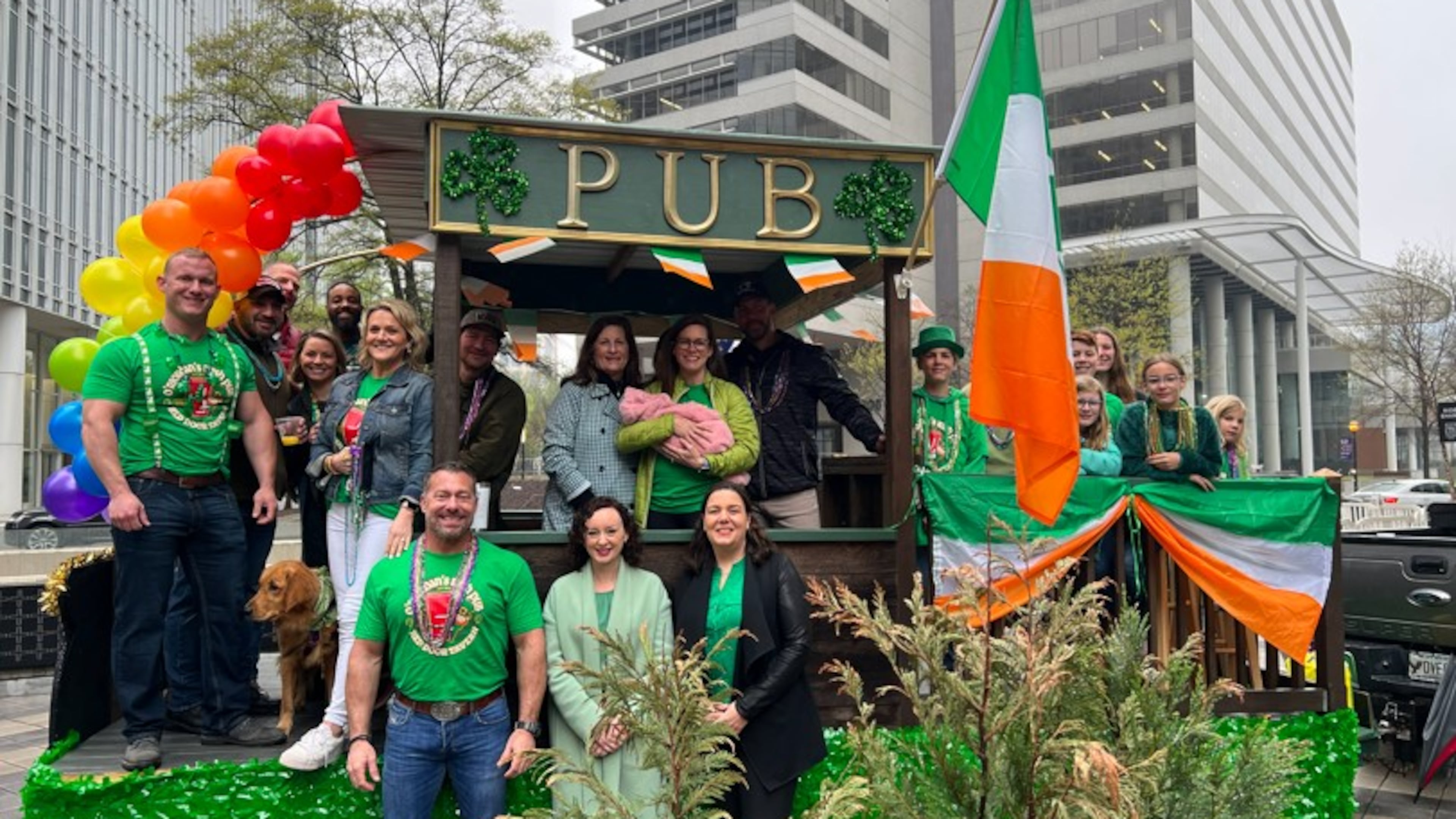 Mike Riordan (front left) poses in front of an Atlanta St. Patrick's Parade float along with former Irish Consul General Caoimhe Ní Chonchúir (center) and Irish Network Atlanta Parade Committee Chair Sinead Connaughton (right), in addition to other members of the Riordan family. (Courtesy of the Riordan family)