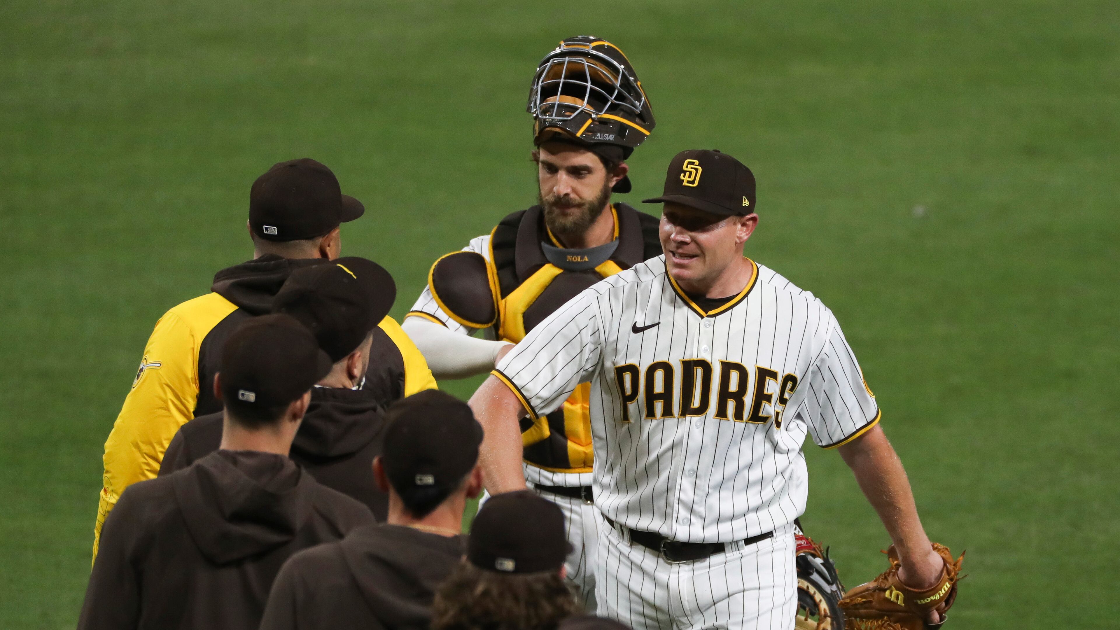 San Diego Padres relief pitcher Mark Melancon is congratulated by teammates after the team's 6-4 win over the Seattle Mariners in a baseball game Saturday, May 22, 2021, in San Diego. (AP Photo/Derrick Tuskan)