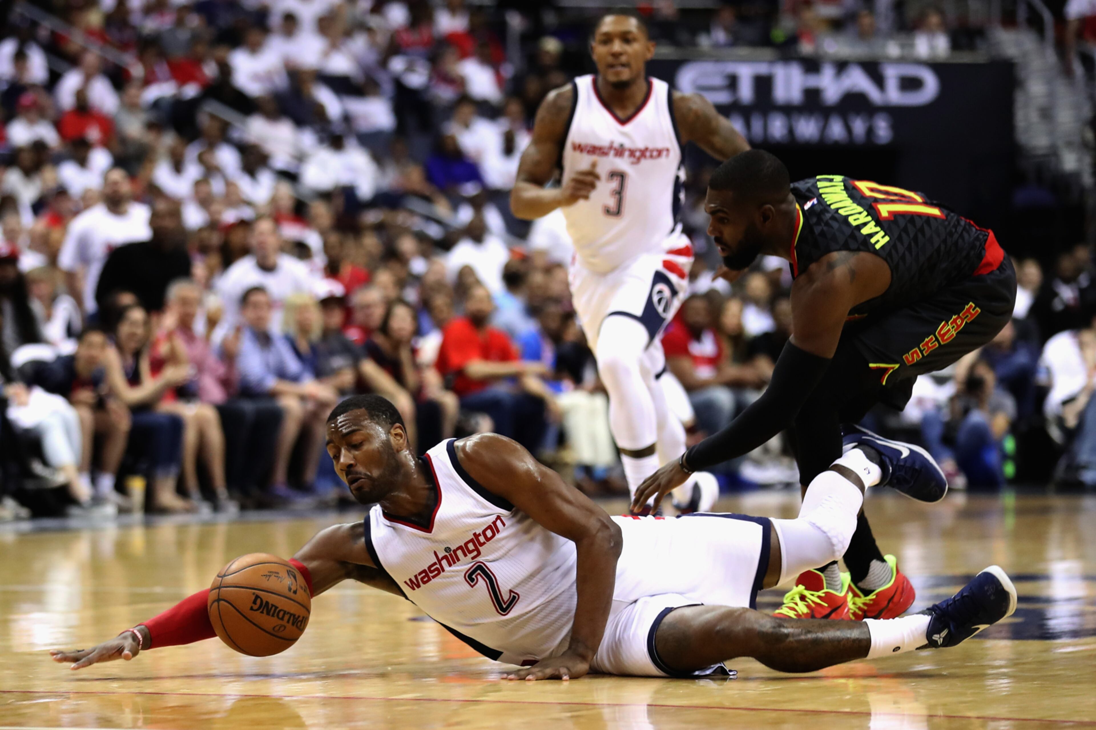 WASHINGTON, DC - APRIL 16: John Wall #2 of the Washington Wizards and Tim Hardaway Jr. #10 of the Atlanta Hawks go after a loose ball in the first half of Game One of the Eastern Conference Quarterfinals during the 2017 NBA Playoffs at Verizon Center on April 16, 2017 in Washington, DC. NOTE TO USER: User expressly acknowledges and agrees that, by downloading and or using this photograph, User is consenting to the terms and conditions of the Getty Images License Agreement. (Photo by Rob Carr/Getty Images) *** BESTPIX ***