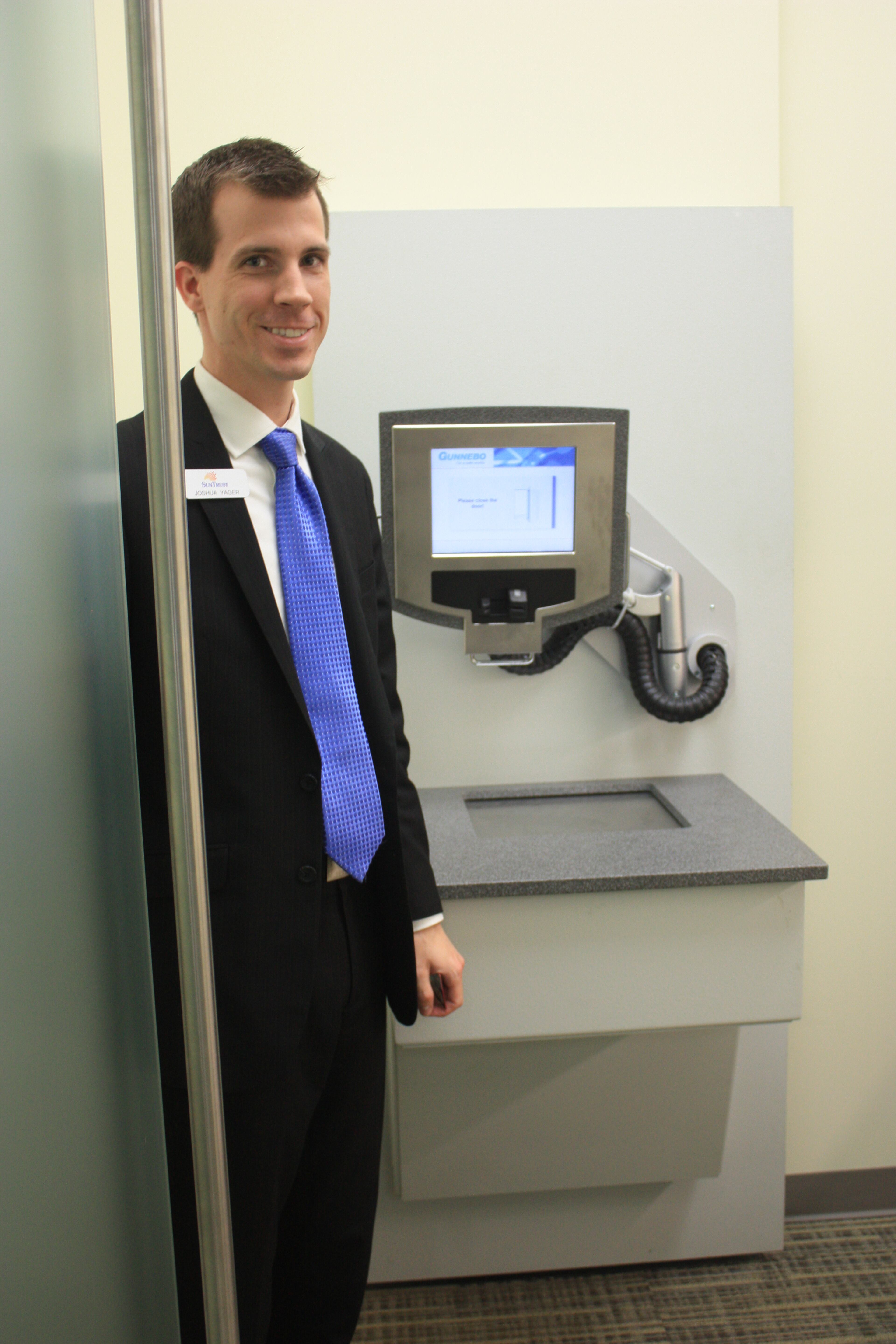 Behind the thick glass door is a terminal that looks something like an ATM.