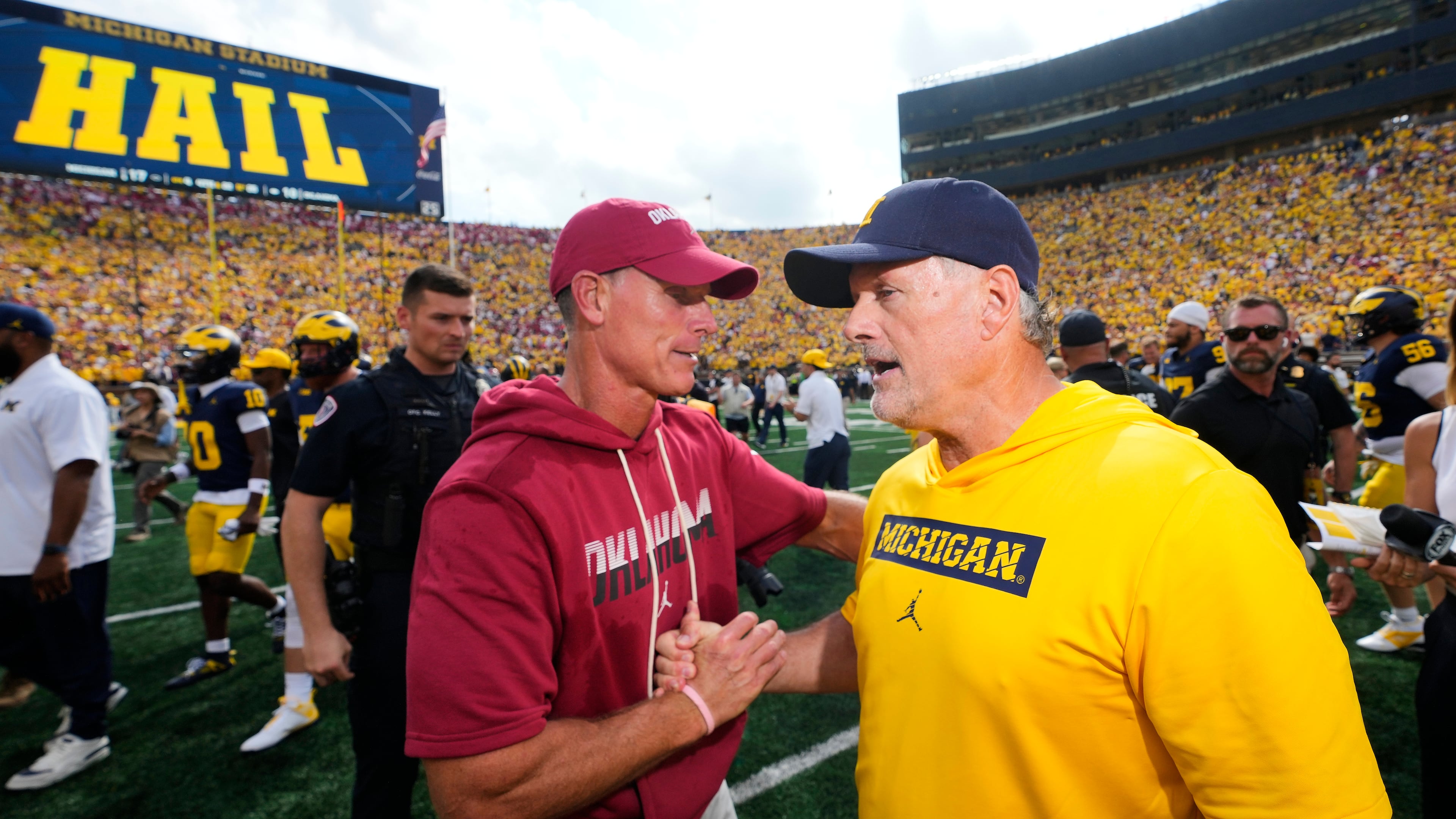 Oklahoma head coach Brent Venables, left, and Michigan head coach Kyle Whittingham, right, shake hands after an NCAA college football game Saturday, Sept. 12, 2026, in Ann Arbor, Mich. (AP Photo/Paul Sancya)