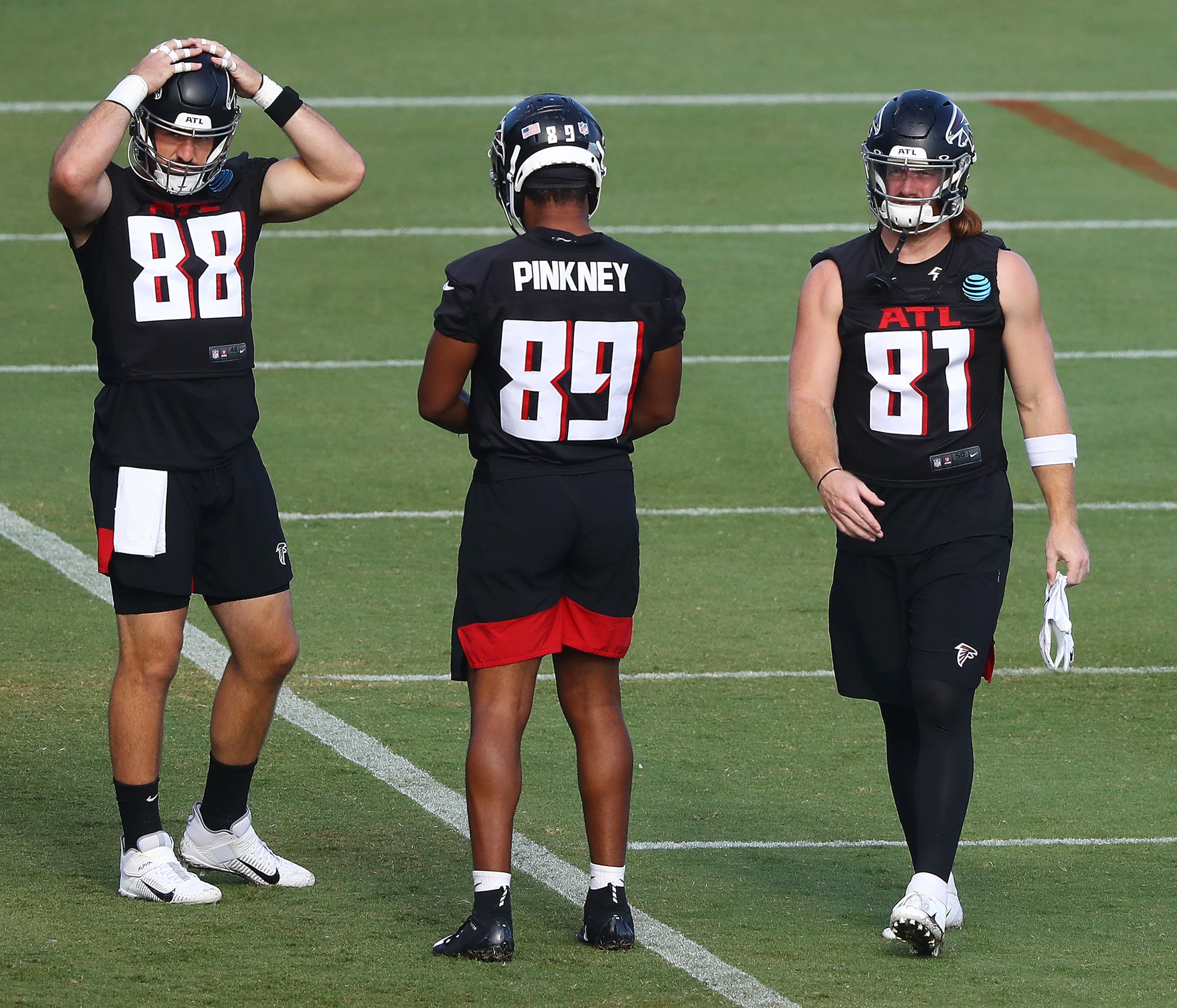 Falcons tight ends Luke Stocker (from left), Jared Pinkney and Hayden Hurst take the field for practice Wednesday, Aug.19, 2020, in Flowery Branch.