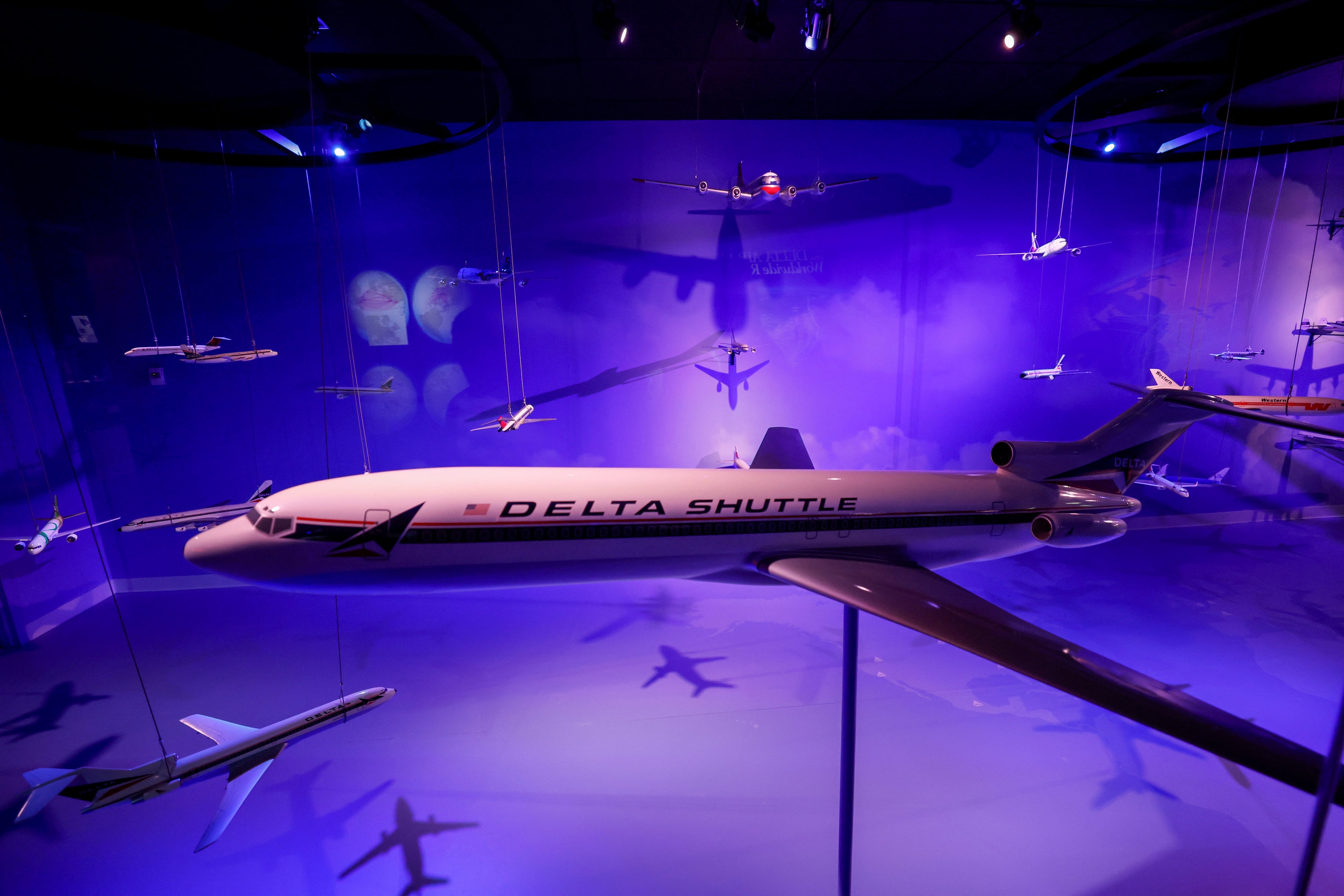 A collection of Delta airplane models is on display inside the Delta in Motion room at the recently remodeled Delta Flight Museum near Hartsfield-Jackson Atlanta International Airport on Tuesday, March 25, 2025. Starting April 7, the public will have the opportunity to engage with the new interactive experience. (Miguel Martinez/AJC)