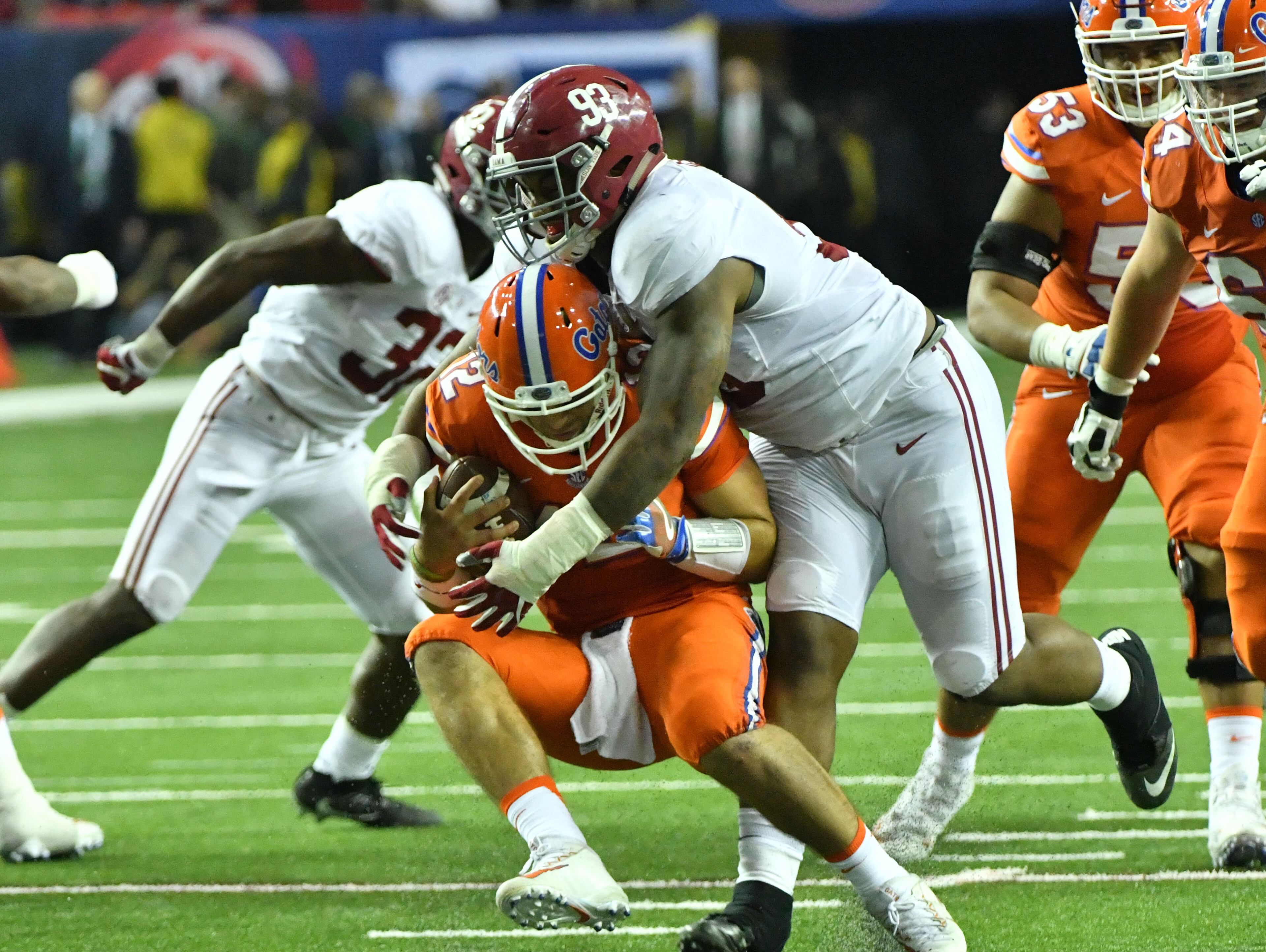 December 3, 2016 Atlanta - Florida quarterback Austin Appleby (12) is brought down by Alabama defensive lineman Jonathan Allen (93) in the second half of the 2016 SEC Championship at the Georgia Dome on Saturday, December 3, 2016. Alabama won 54 - 16 over the Florida. HYOSUB SHIN / HSHIN@AJC.COM