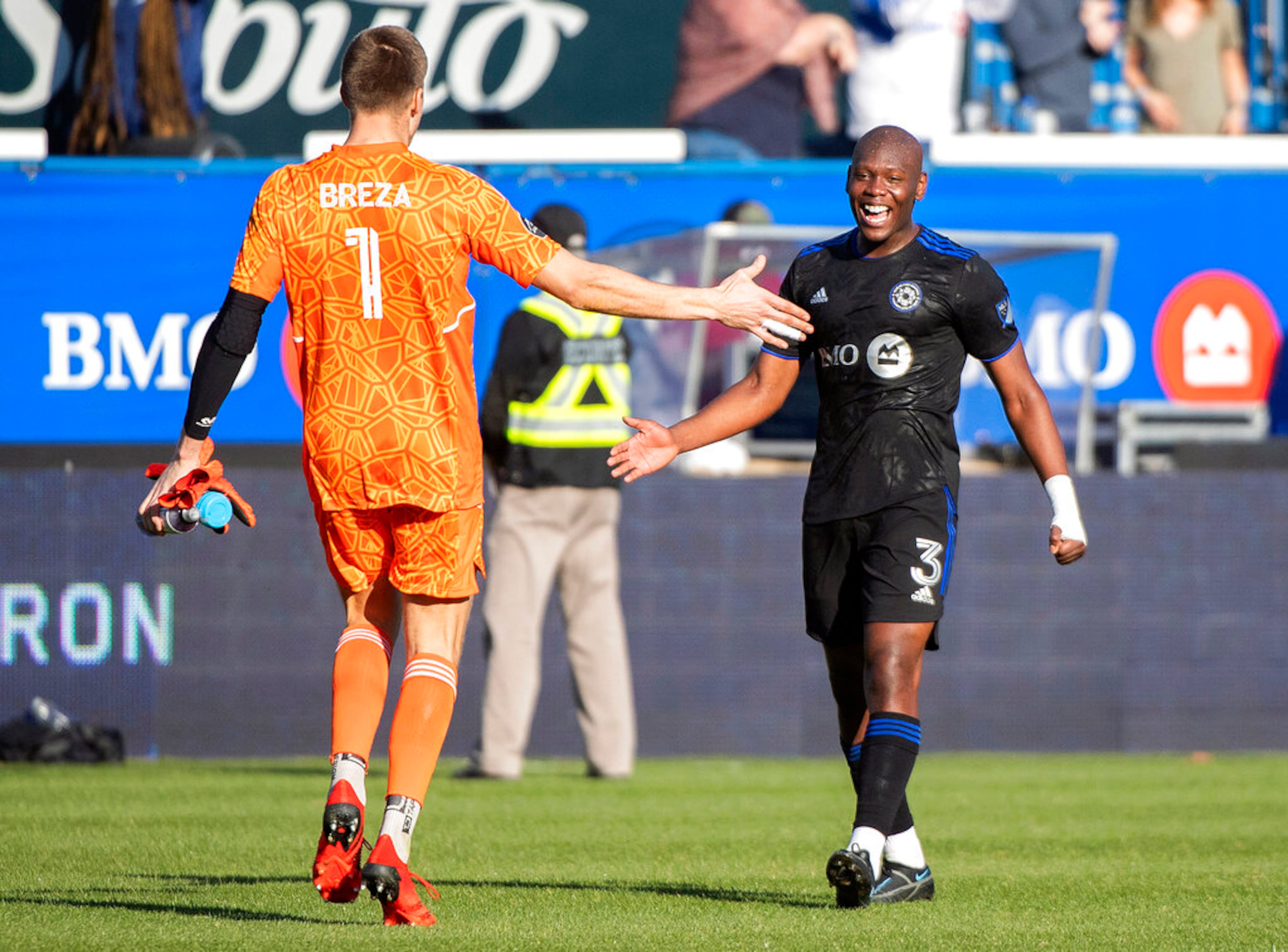 CF Montreal's goalkeeper Sebastian Breza (1) celebrates with teammate Kamal Miller after defeating Atlanta United in an MLS soccer game in Montreal, Saturday, April 30, 2022. (Graham Hughes/The Canadian Press via AP)