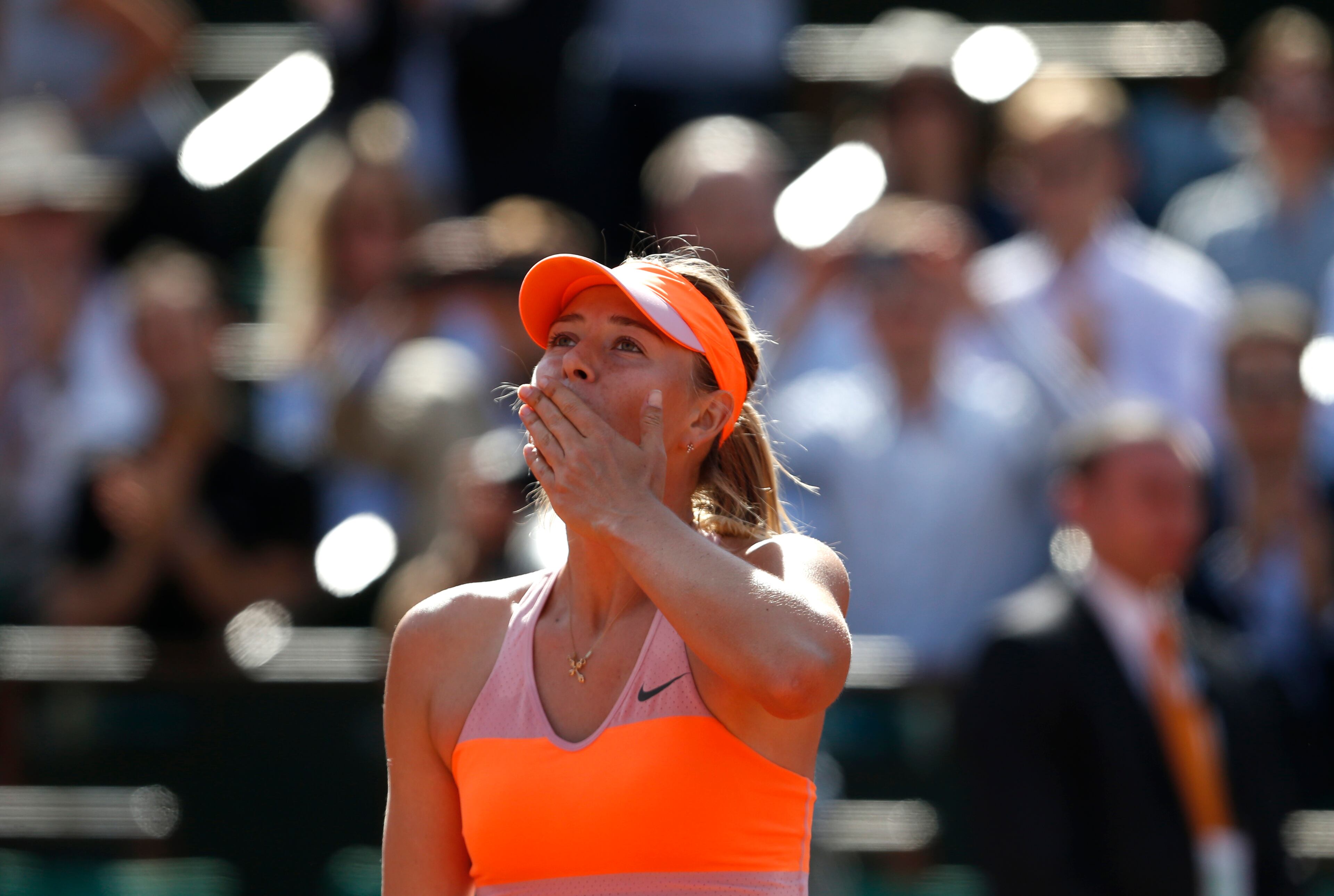 Russia's Maria Sharapova blows a kiss to the public after defeating Canada's Eugenie Bouchard during their semifinal match of the French Open tennis tournament at the Roland Garros stadium, in Paris, France, Thursday, June 5, 2014. Sharapova won 4-6, 7-5, 6-2. (AP Photo/Darko Vojinovic)