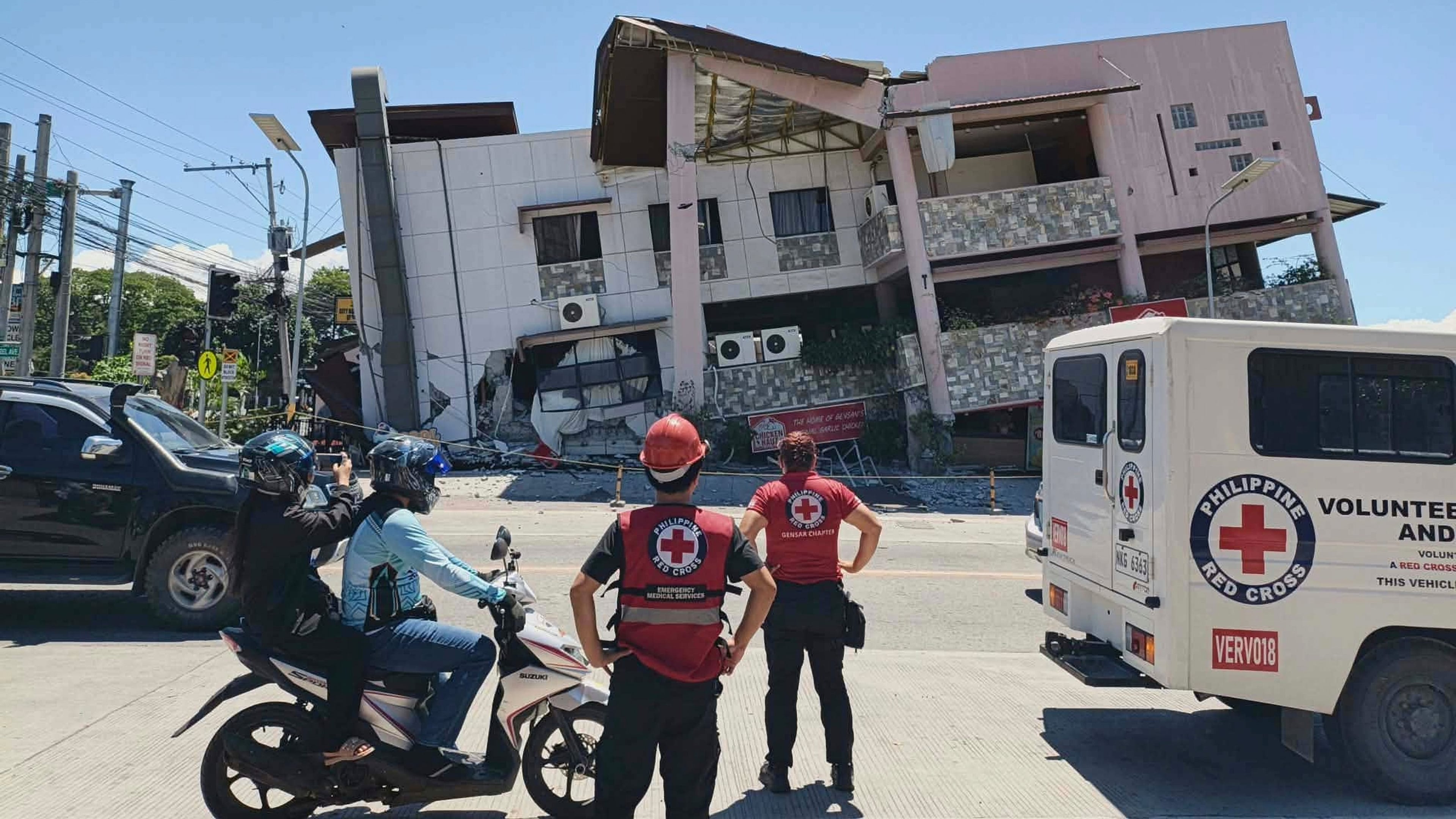 In this photo provided by the Philippine Red Cross, rescuers inspect the damage after an earthquake in General Santos, Philippines, Monday, June 8, 2026. (Philippine Red Cross via AP)