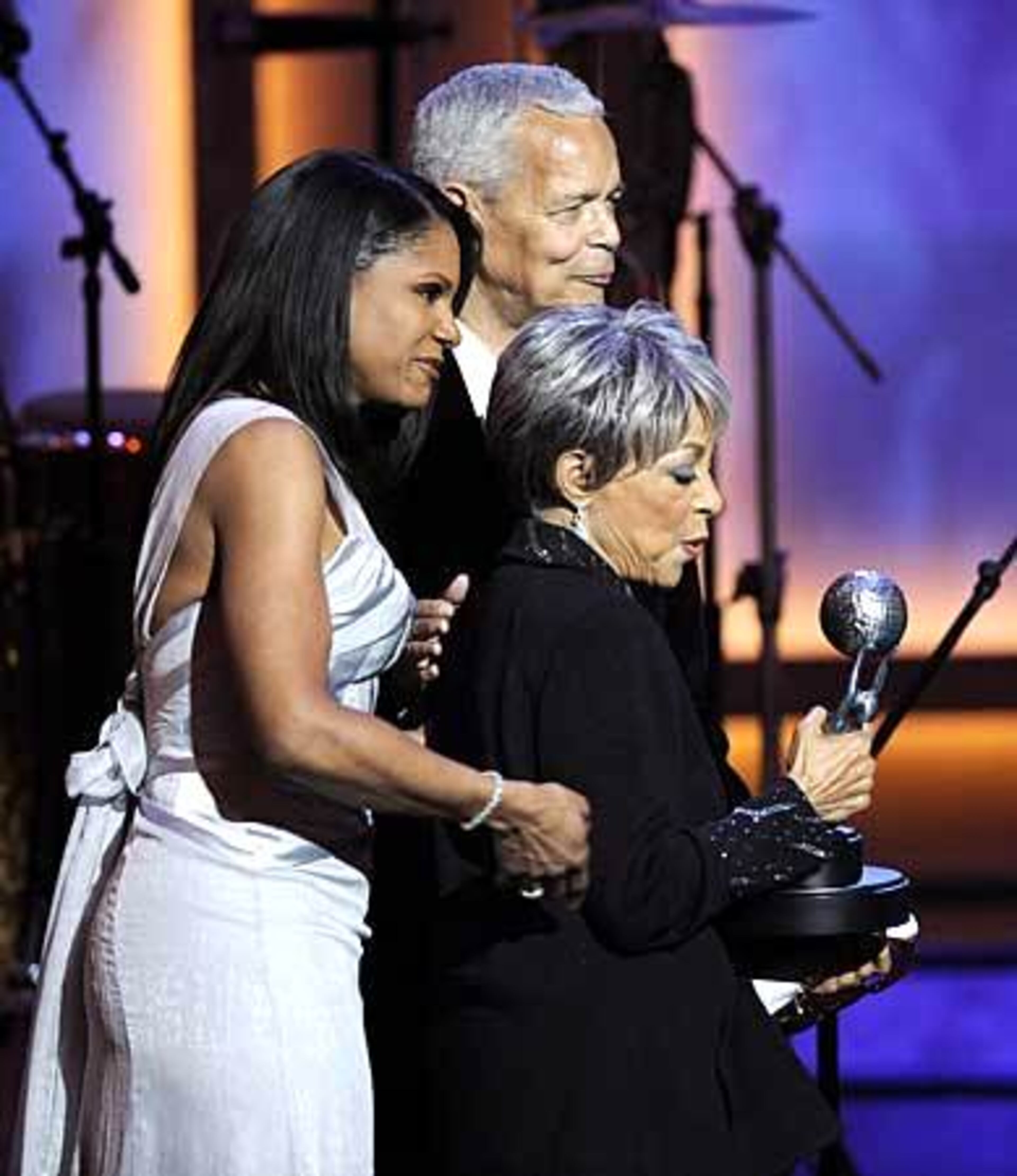 Ruby Dee walks off stage after accepting the Chairman's award from NAACP Chairman Julian Bond, a former Georgia legislator.