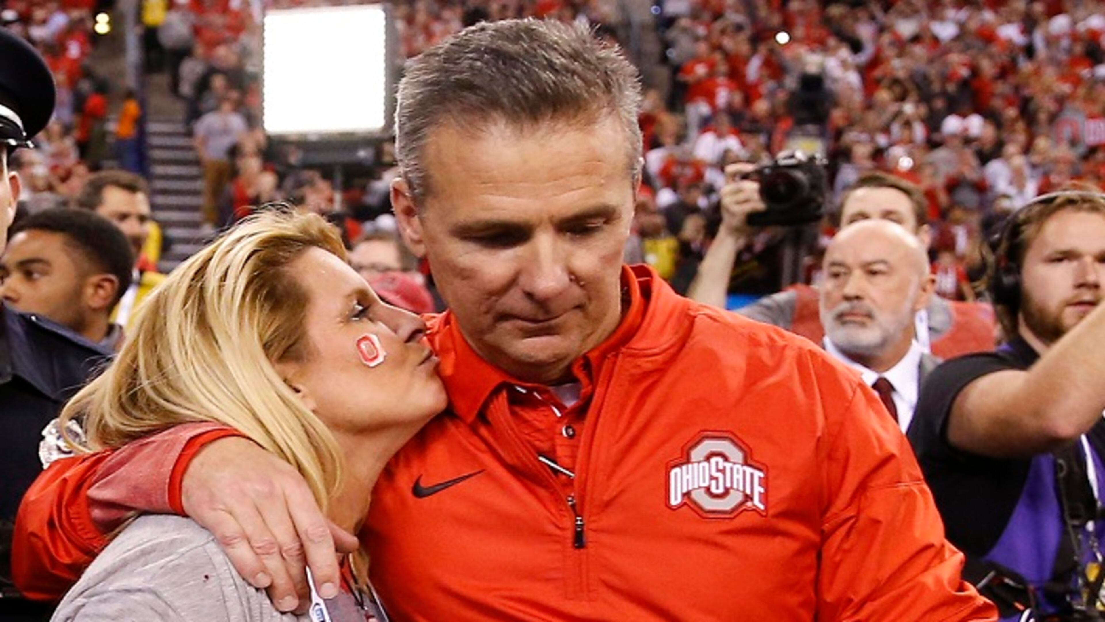 Ohio State Buckeyes head coach Urban Meyer gets a kiss after his team's 27-21 Big Ten Champsionship win over the Wisconsin Badgers at Lucas Oil Stadium Sunday, Dec. 3, 2017 in Indianapolis. (Sam Riche/TNS)