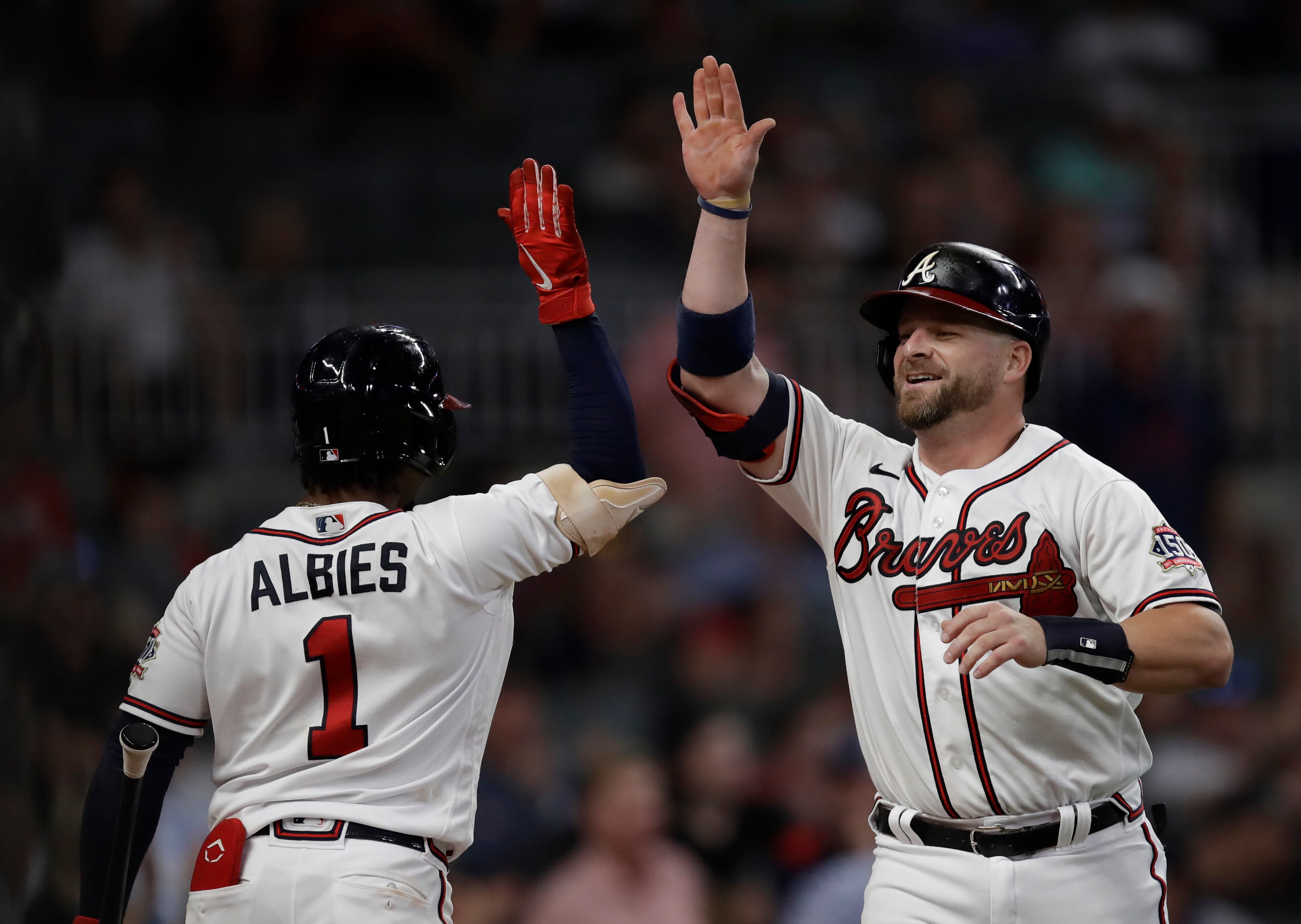 Atlanta Braves' Stephen Vogt, right, celebrates with Ozzie Albies (1) after hitting a home run off Washington Nationals pitcher Erick Fedde during the third inning of a baseball game Thursday, Sept. 9, 2021, in Atlanta. (AP Photo/Ben Margot)