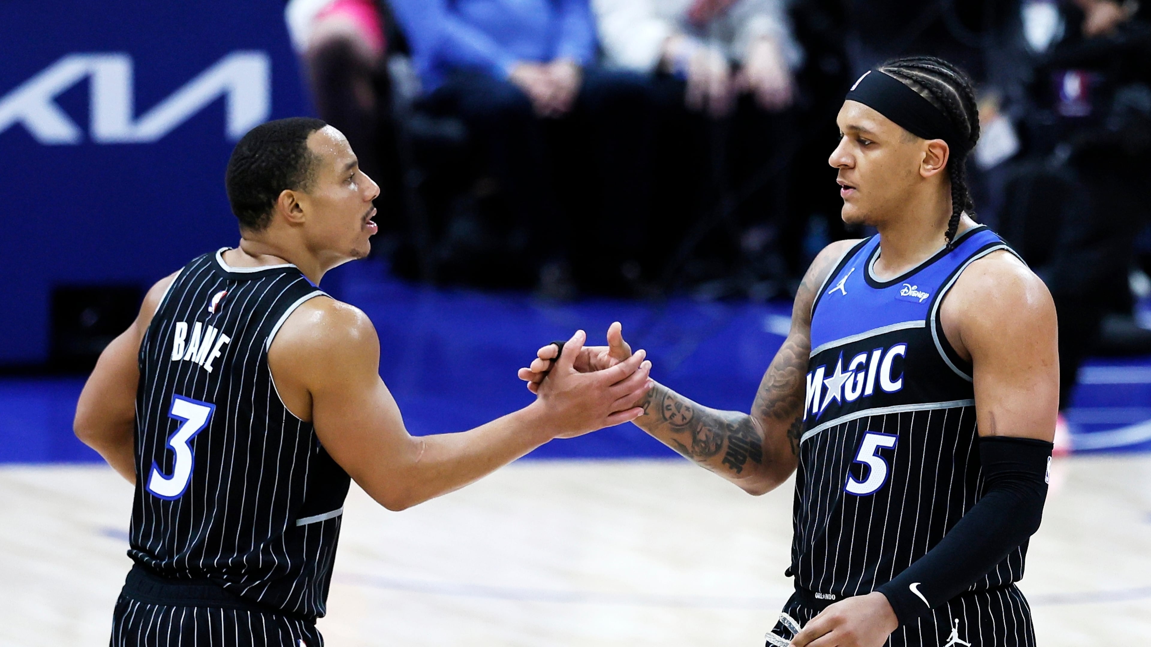 Orlando Magic guard Desmond Bane (3) celebrates with forward Paolo Banchero (5) after a win over the Detroit Pistons in Game 1 of a first-round NBA basketball playoffs series Sunday, April 19, 2026, in Detroit. (AP Photo/Duane Burleson)