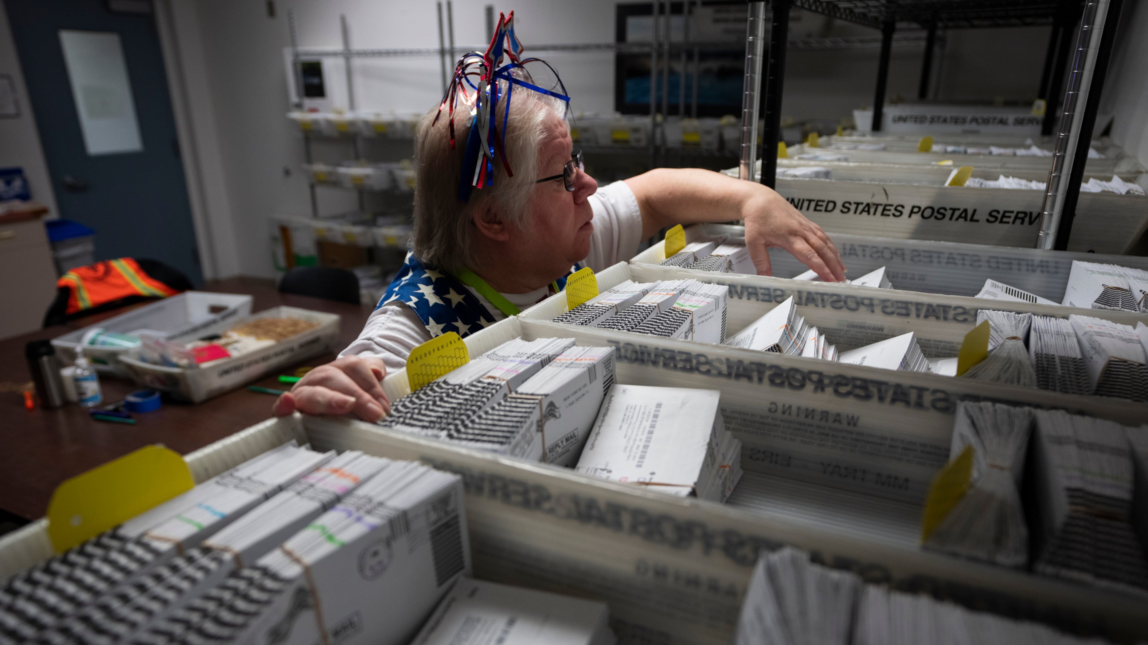 FILE - Election worker Wendy Wimer looks through vote-by-mail ballots for the presidential primary election, March 12, 2024, at the Clark County Elections Office in Vancouver, Wash. (AP Photo/Jenny Kane, File)