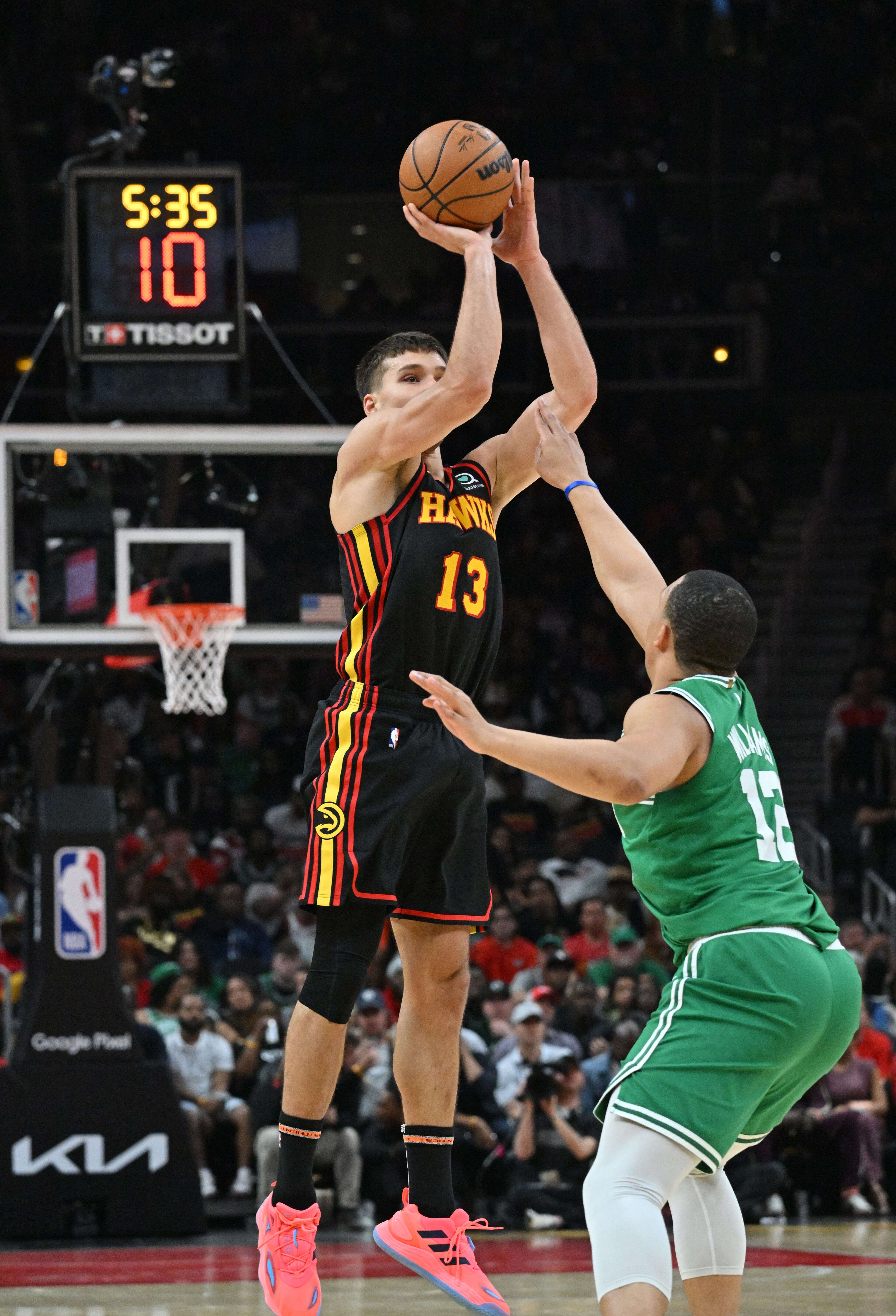 Atlanta Hawks' guard Bogdan Bogdanovic (13) shoots over Boston Celtics' forward Grant Williams (12) during the first half in Game 3 of the first round of the Eastern Conference playoffs at State Farm Arena, Friday, April 21, 2023, in Atlanta. (Hyosub Shin / Hyosub.Shin@ajc.com)