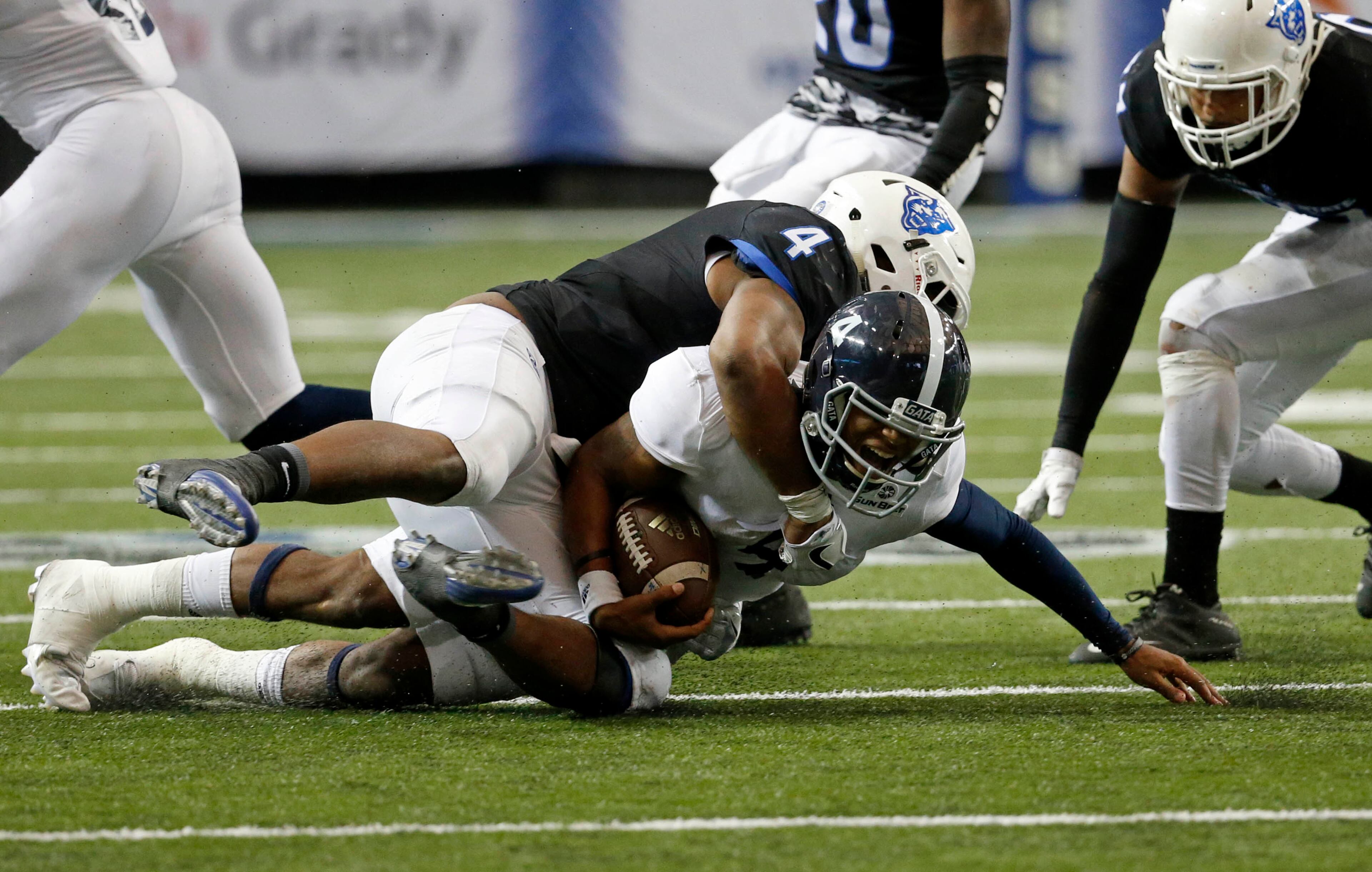 November 19, 2016 - Atlanta, Ga: Georgia State Panthers linebacker Alonzo McGee (4) tackles Georgia Southern Eagles quarterback Kevin Ellison (4) for a short gain in the second half of their game at the Georgia Dome Saturday November 19, 2016, in Atlanta, Ga. Georgia State won 30-24. PHOTO / JASON GETZ