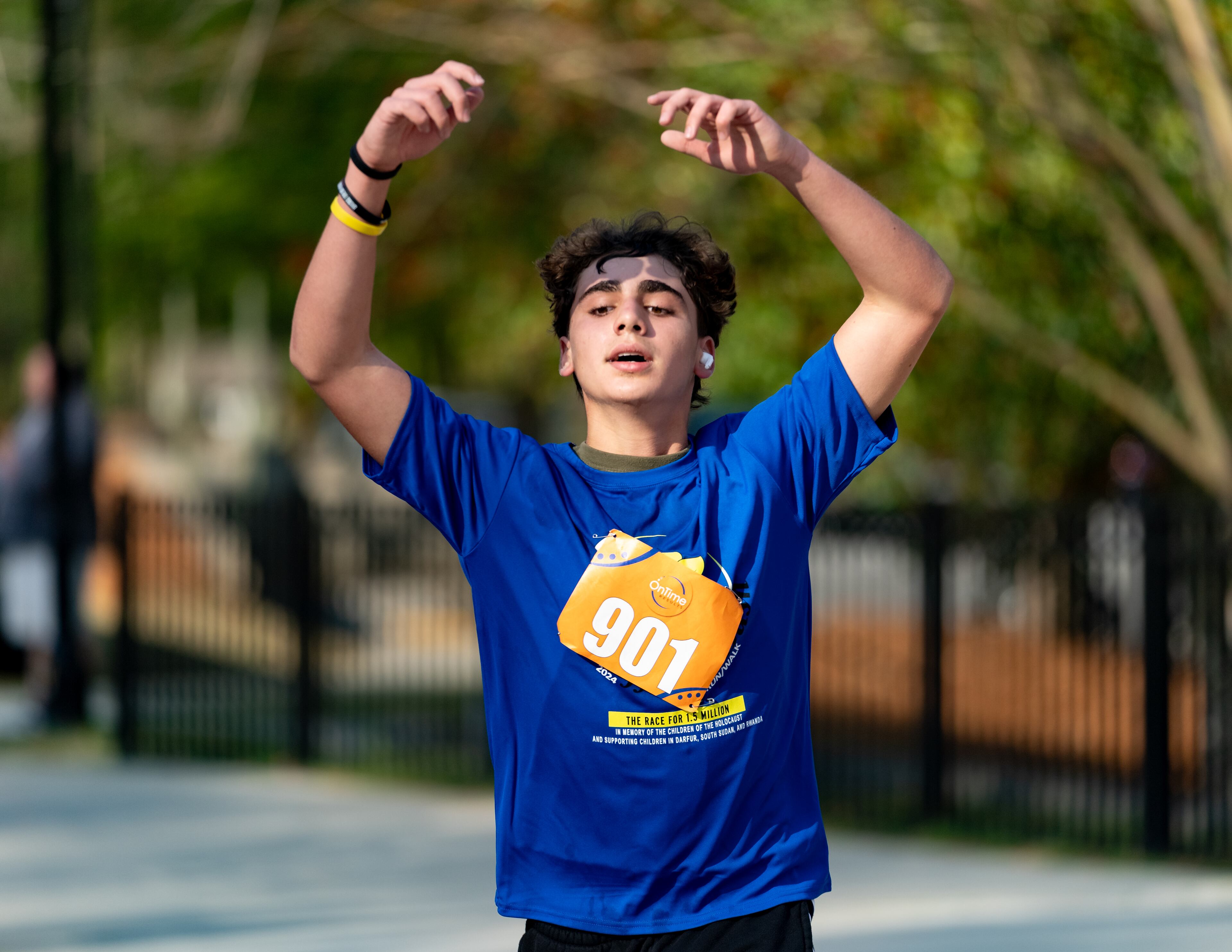 Edan Cohen celebrates after crossing the finish line at the Daffodil Dash at Brook Run Park in Dunwoody on Sunday, April 7, 2024. (Ben Hendren for The Atlanta Journal-Constitution)