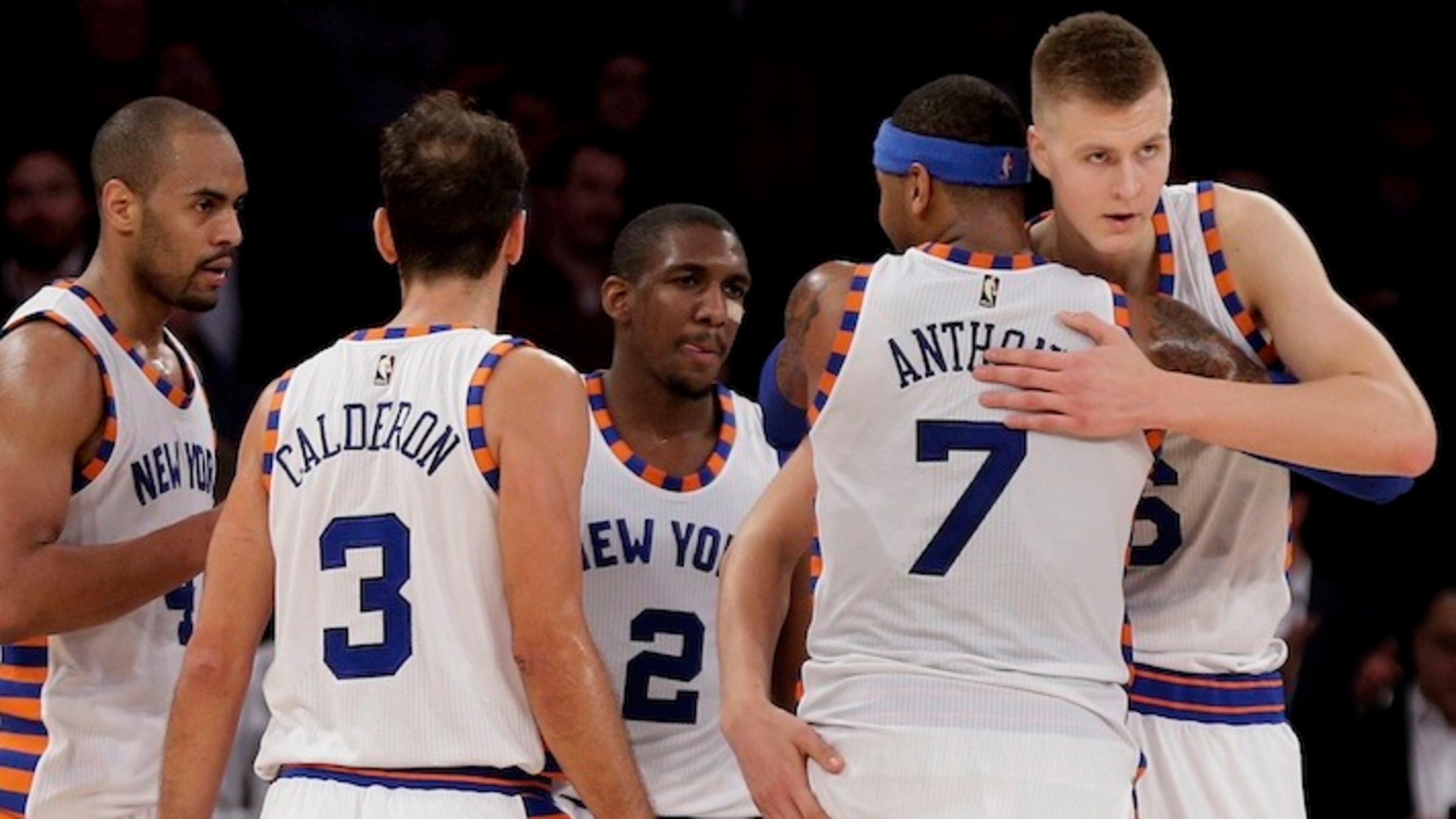New York Knicks forward Carmelo Anthony (7) hugs New York Knicks forward Kristaps Porzingis (6) as they huddle with guard Arron Afflalo (4), guard Jose Calderon (3) and guard Langston Galloway (2) during the fourth quarter of an NBA basketball game against the Charlotte Hornets, Tuesday, Nov. 17, 2015, in New York. (AP Photo/Julie Jacobson)
