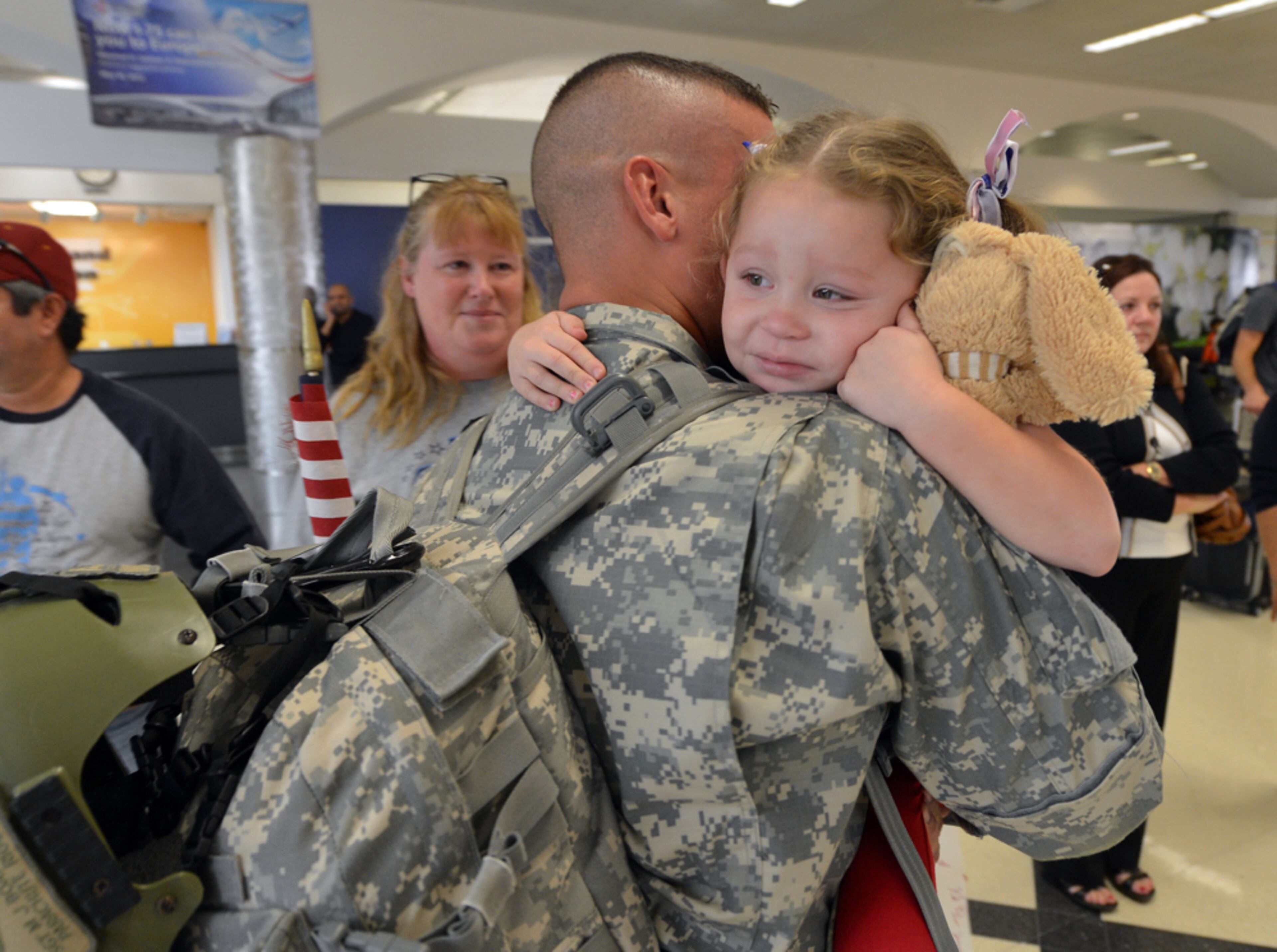 October 19, 2012: Back in daddy's arms. Sgt. Michael Boatwright hugs his daughter, Kayan,4, after returning from Afghanistan October 19, 2012. Photographing arrival or departure ceremonies for the military is just heart wrenching. BRANT SANDERLIN / BSANDERLIN@AJC.COM