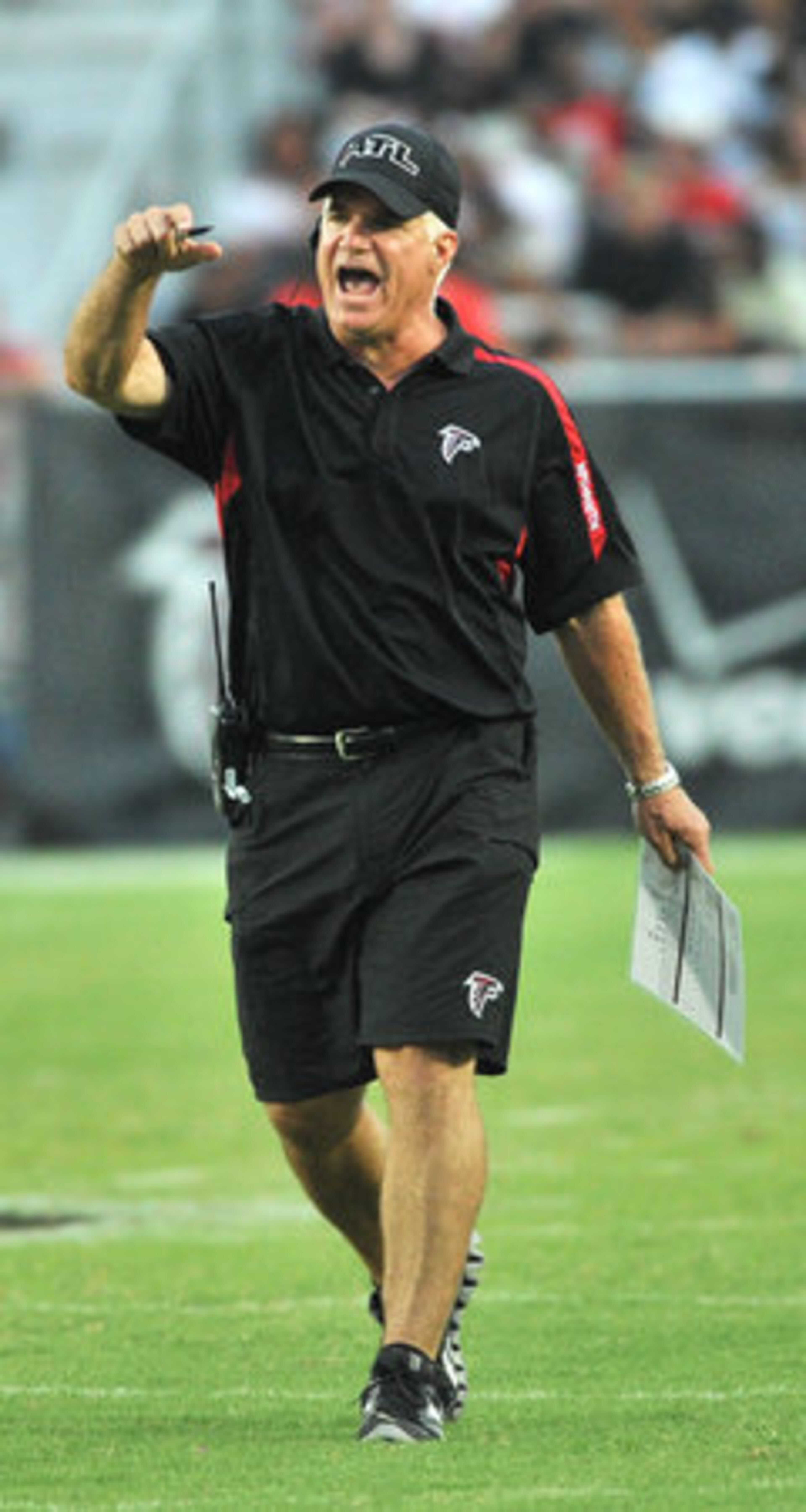 Atlanta Falcons head coach Mike Smith shouts out during the Friday Night Lights at North Gwinnett High School in Suwanee.
