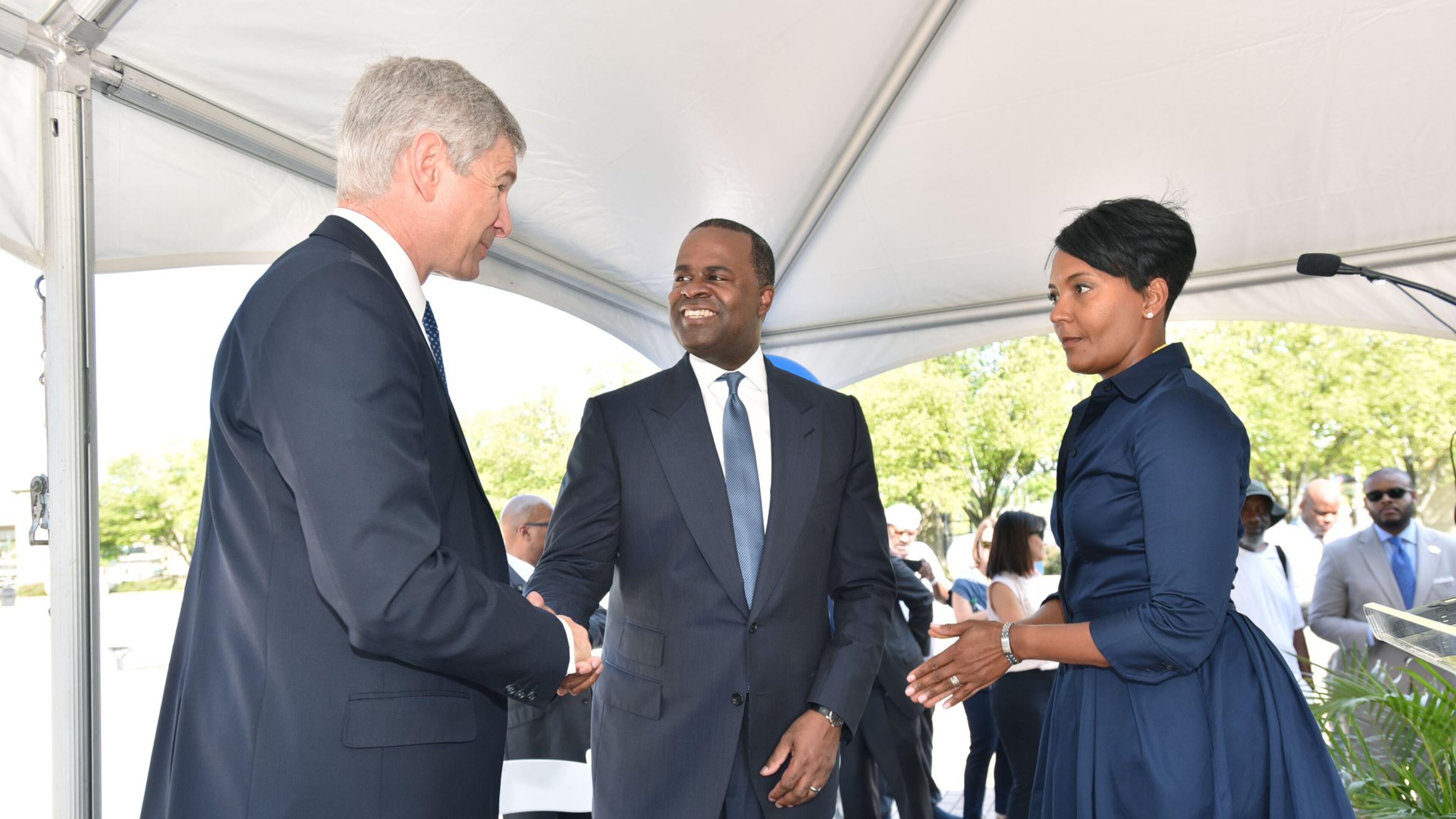 AUGUST 18, 2016 — Georgia State University President Mark Becker (left) and Atlanta Mayor Kasim Reed shake hands as Atlanta City Councilwoman Keisha Lance Bottoms (right) looks on following an announcement on Aug. 18, 2016, that a deal had been reached for Georgia State and its development partners to purchase Turner Field, the 20-year-old former Olympic stadium and former home of the Atlanta Braves. Councilwoman Bottoms is also director of the Atlanta Fulton County Recreation Authority. The Rec Authority and the Braves are fighting over money now that the team has left Atlanta for Cobb County. (Photo: Hyosub Shin/ hshin@ajc.com)