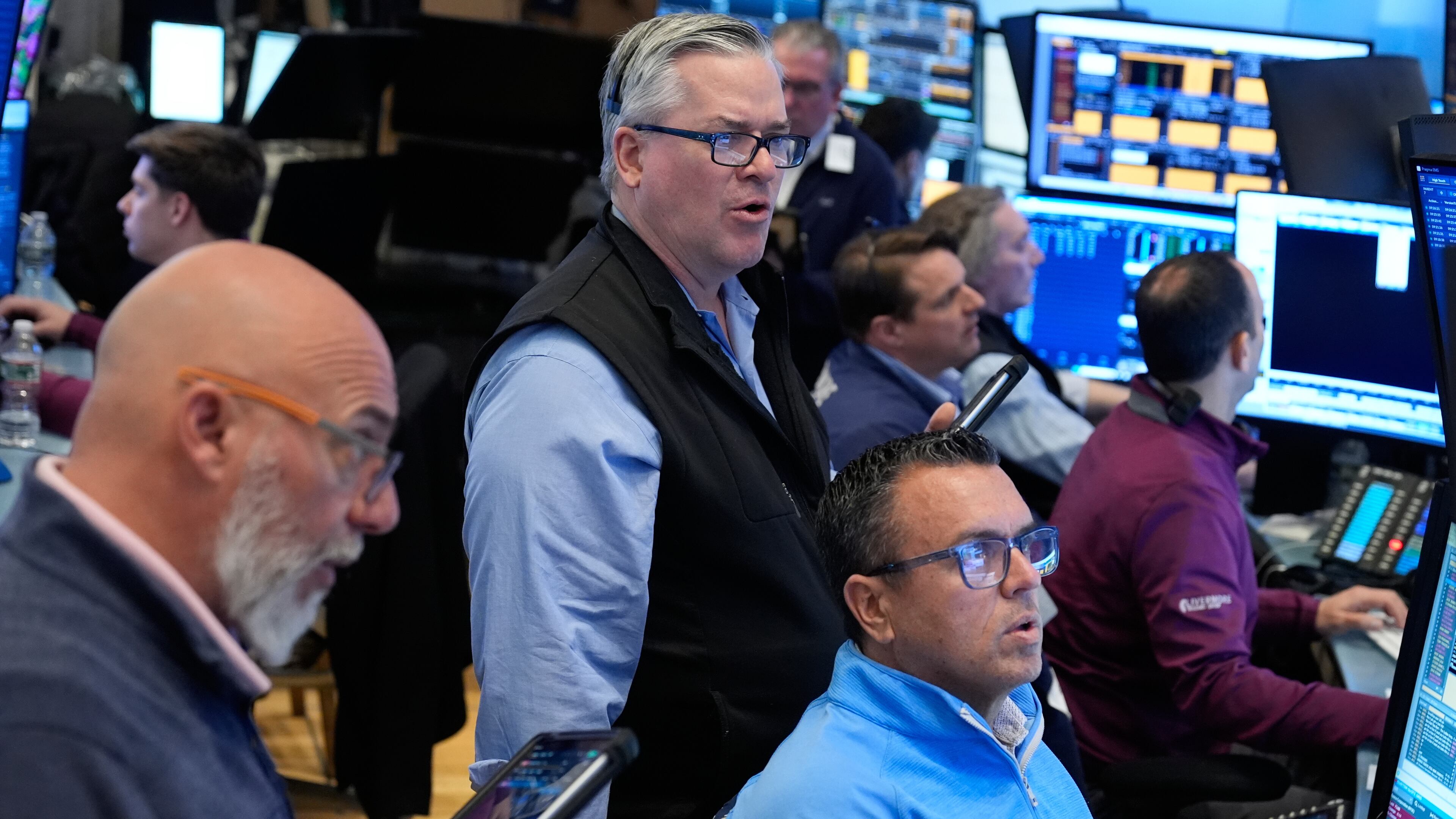 People work on the floor at the New York Stock Exchange in New York, Monday, March 30, 2026. (AP Photo/Seth Wenig)