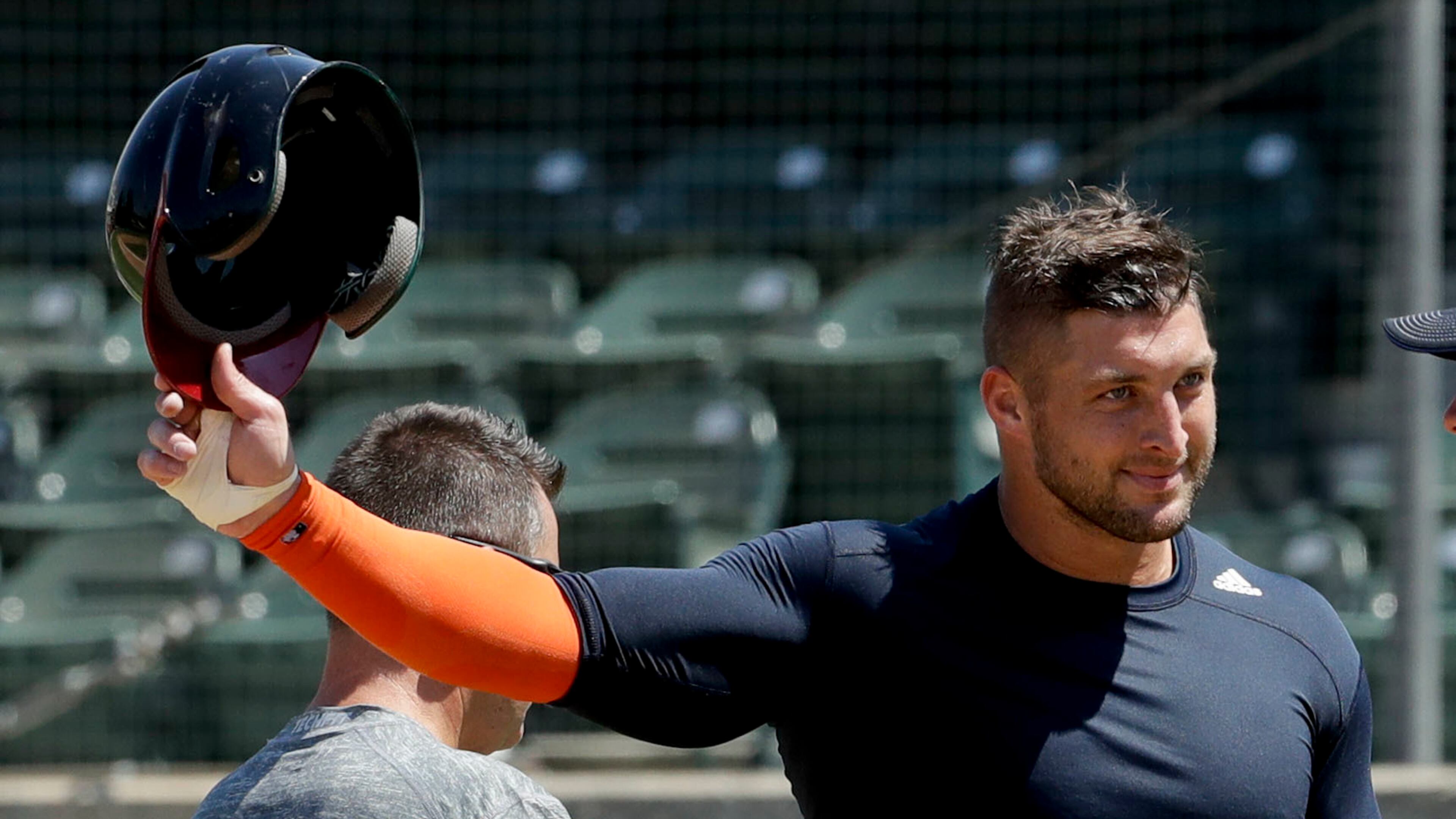 Former NFL quarterback, Tim Tebow finishes his work out for baseball scouts and the media during a showcase on the campus of the University of Southern California, Tuesday, Aug. 30, 2016 in Los Angeles. The Heisman Trophy winner works out for a big gathering of scouts on USC's campus in an attempt to start a career in a sport he hasn't played regularly since high school. (AP Photo/Chris Carlson)