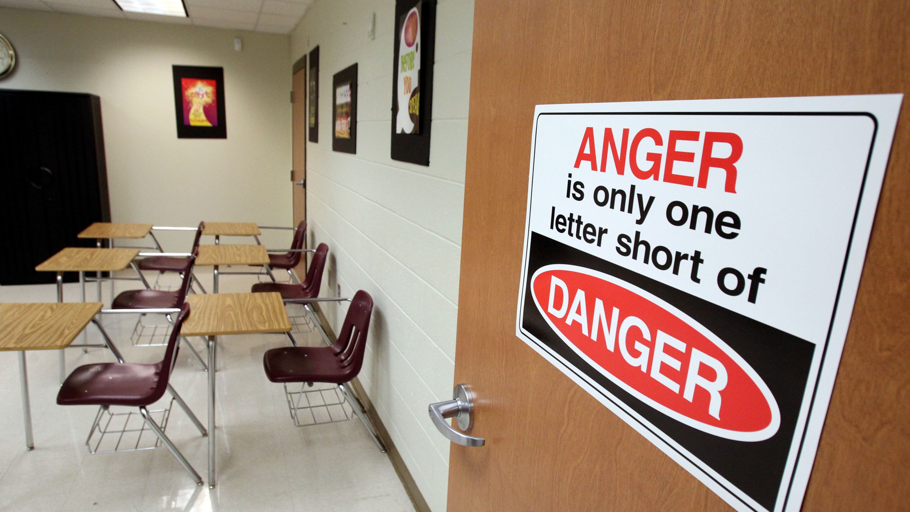A sign reads “Anger is the only one letter short of Danger,” in the room where students wait to be either returned to school or have a parent pick them up at the Atlanta Public Schools Truancy Office, in this photo taken in 2011. ACJ FILE