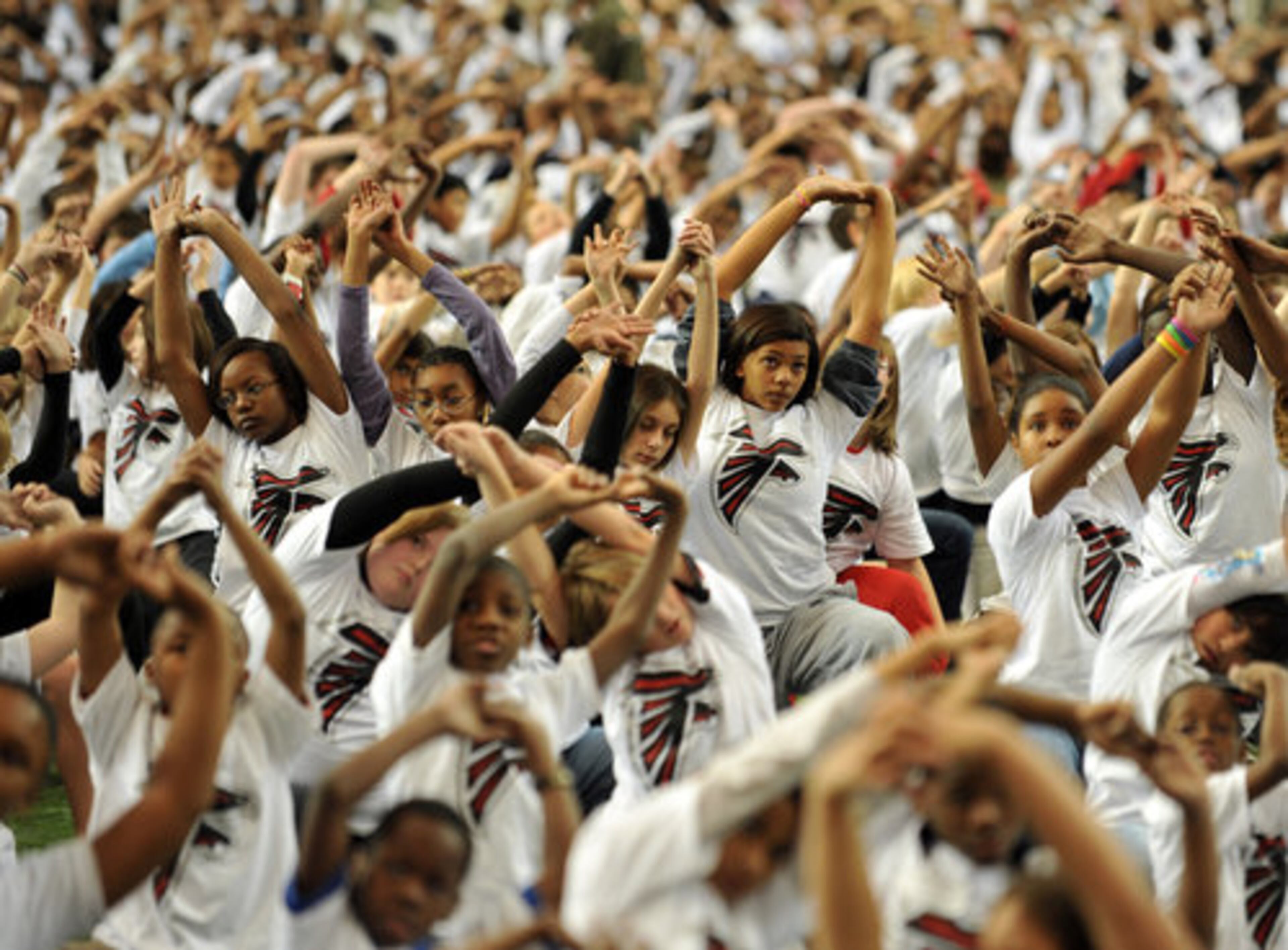 WORLD RECORD WORKOUT-- Atlanta Falcons players, cheerleaders and staff joined metro area school kids to set a Guinness World Record for the largest virtual physical education class at the Georgia Dome Tuesday December 7, 2010. Officially 2288 participants took part in the 30 minute program to beat the old record of 646 set by the Washington Redskins on September 21, 2010. The attempt was organized to spread awareness and emphasize the benefits of exercise and fight childhood obesity.
