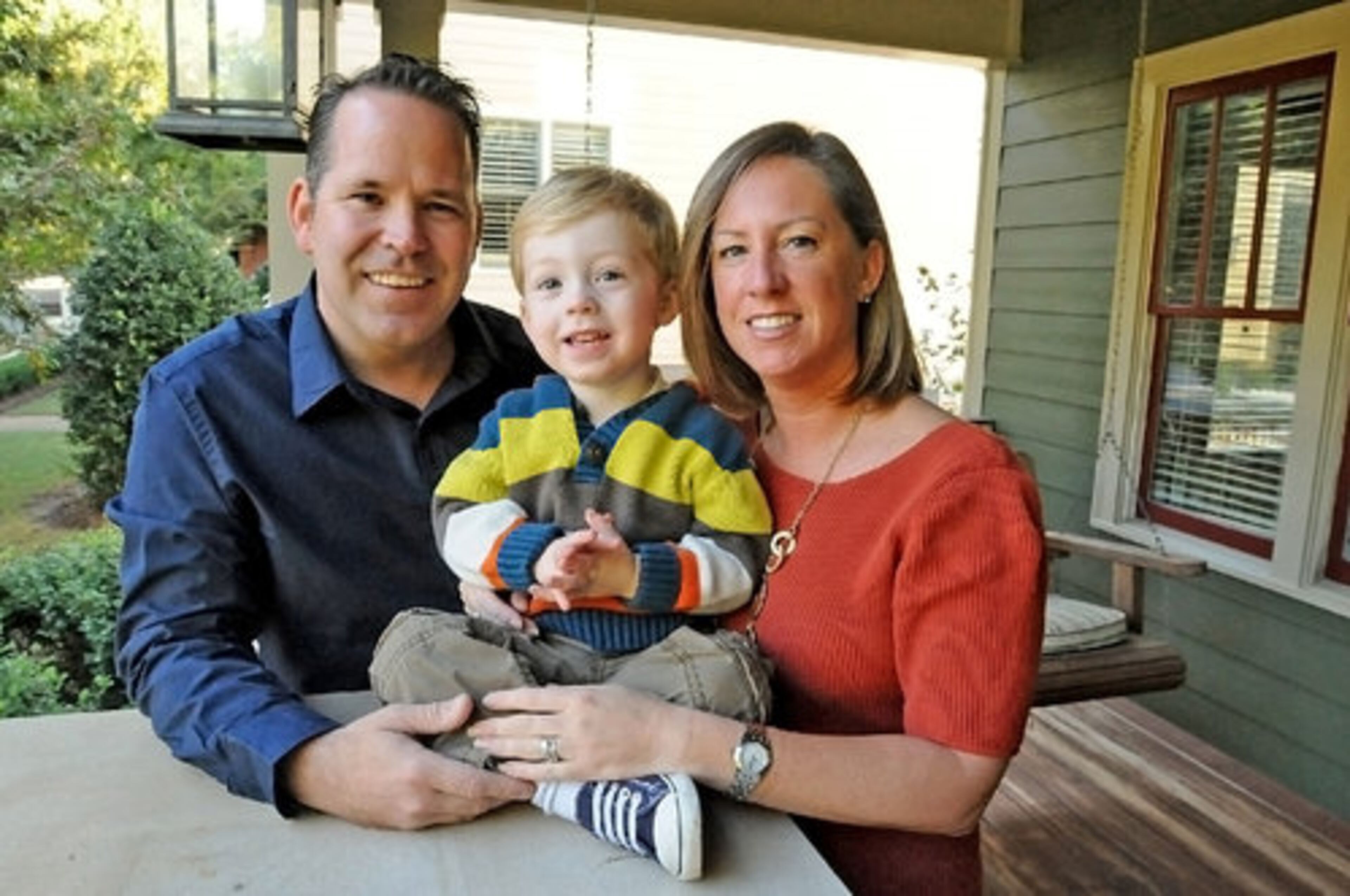Graham and Alana pose with their son Laiton on the porch of their home, located in the Spring Street Village neighborhood of Smyrna. The family desired a homey atmosphere, and have succeeded with their decor choices.