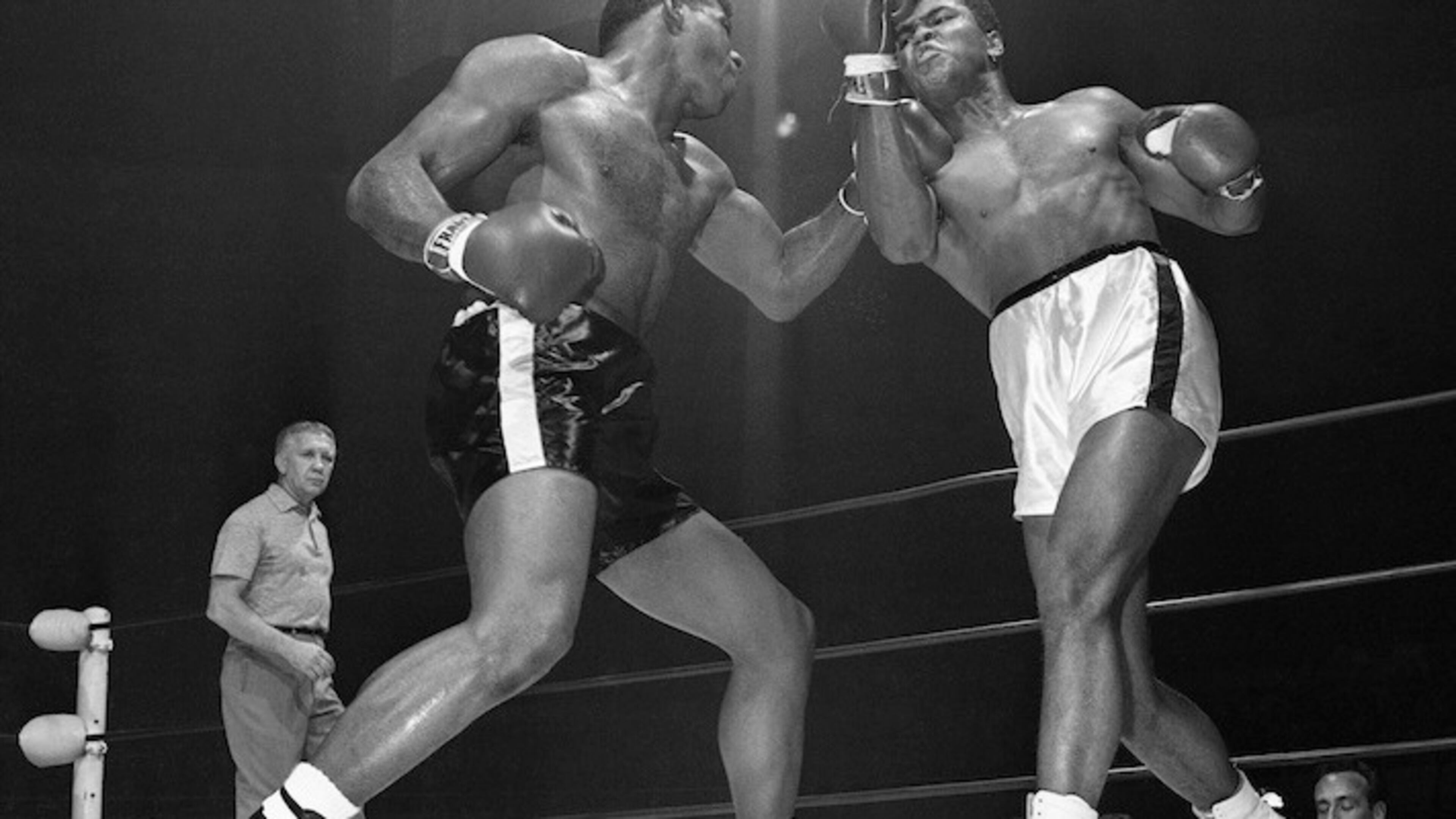 Challenger Floyd Paterson, left, delivers a left hook to the chin of champion Muhammad Ali (Cassius Clay) during the second round of their heavyweight title fight Nov. 22, 1965 in Las Vegas, Nevada. (AP Photo)