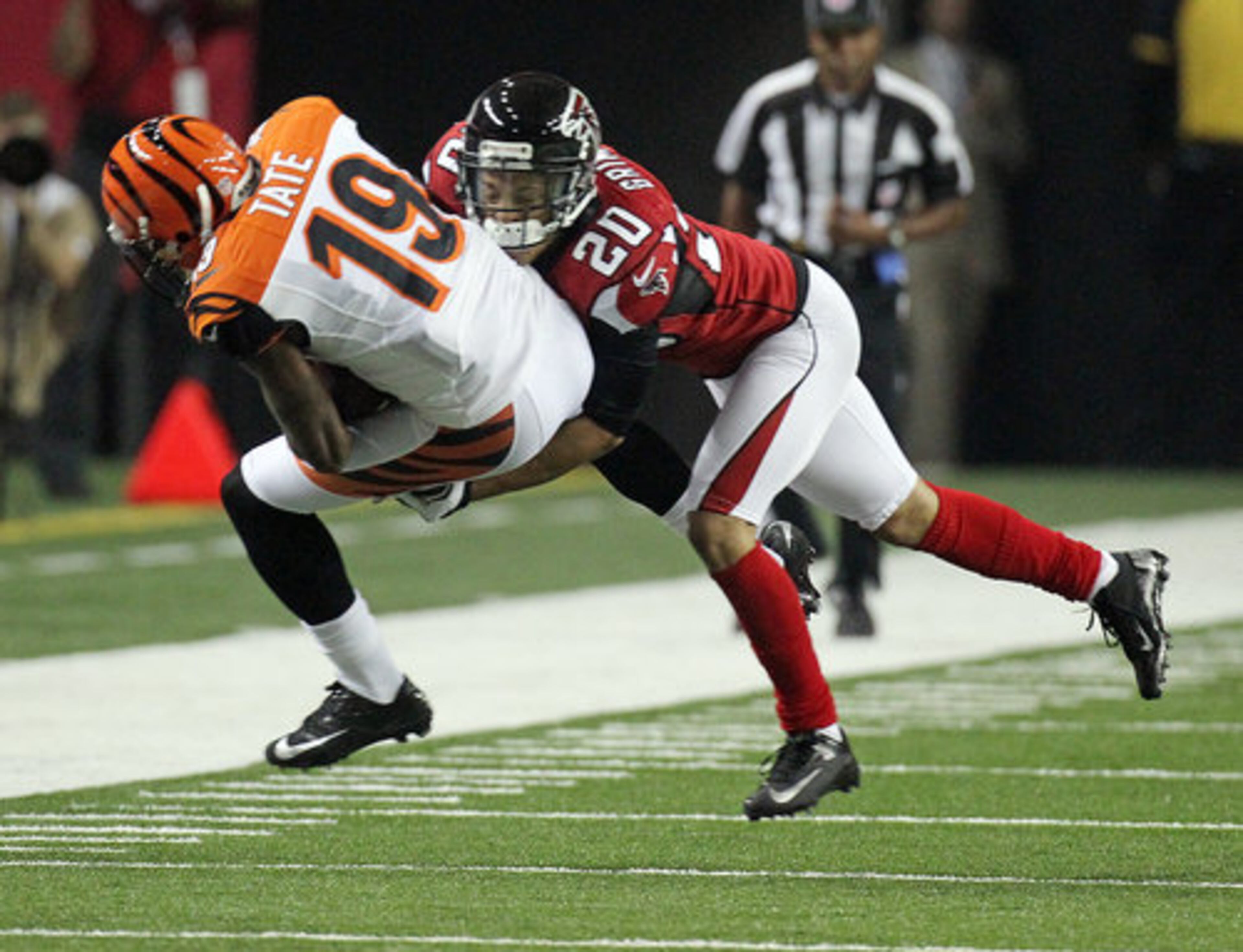 Bengals wide receiver Brandon Tate makes a first down catch and then pays the price with a hit from Falcons cornerback Brent Grimes during 1st half action at the Georgia Dome in Atlanta on Thursday, August 16, 2012.