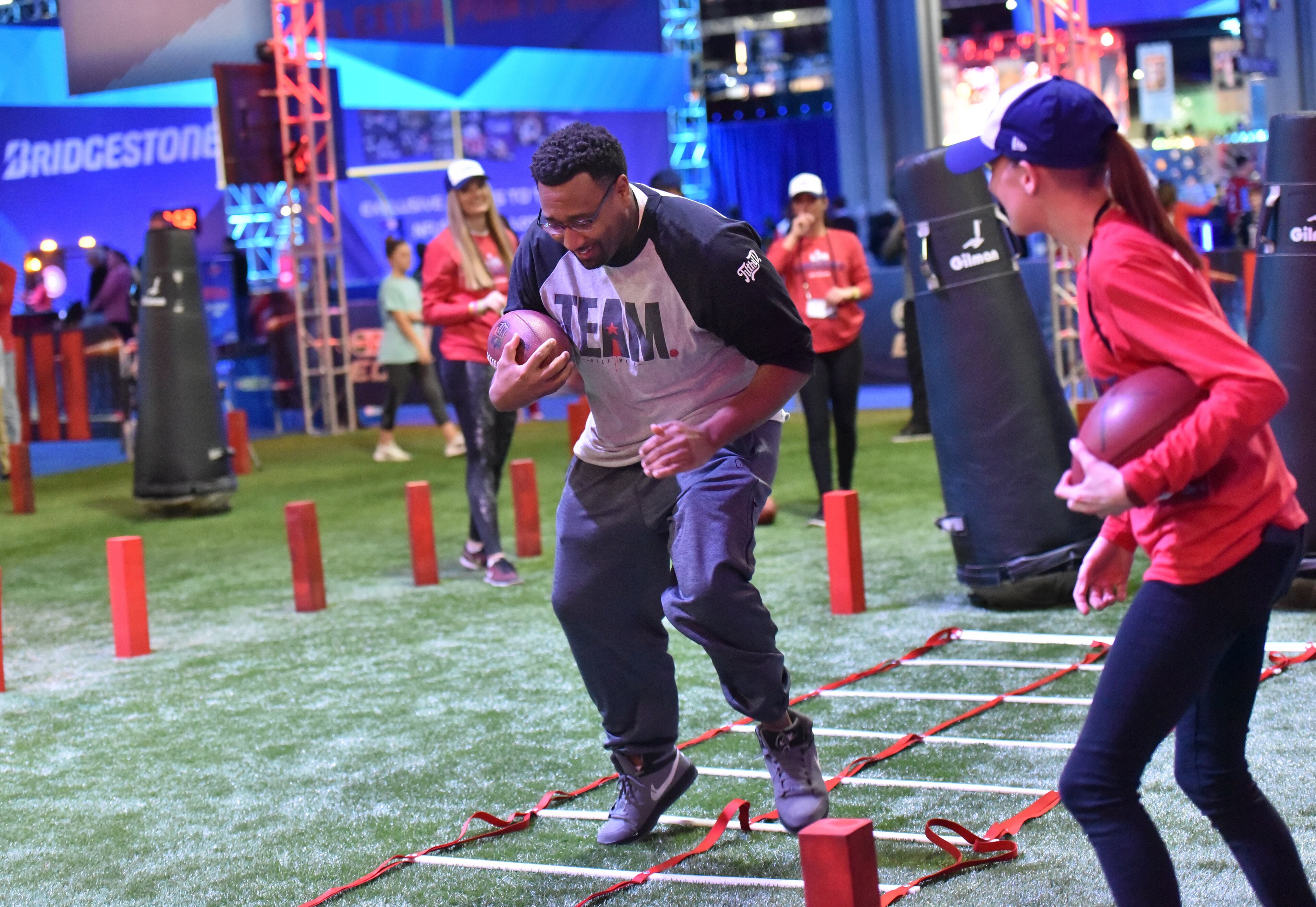 January 30, 2019 Atlanta - A visitor participates in a football drill during Super Bowl Experience inside Georgia World Congress Center on Wednesday, January 30, 2019. HYOSUB SHIN / HSHIN@AJC.COM