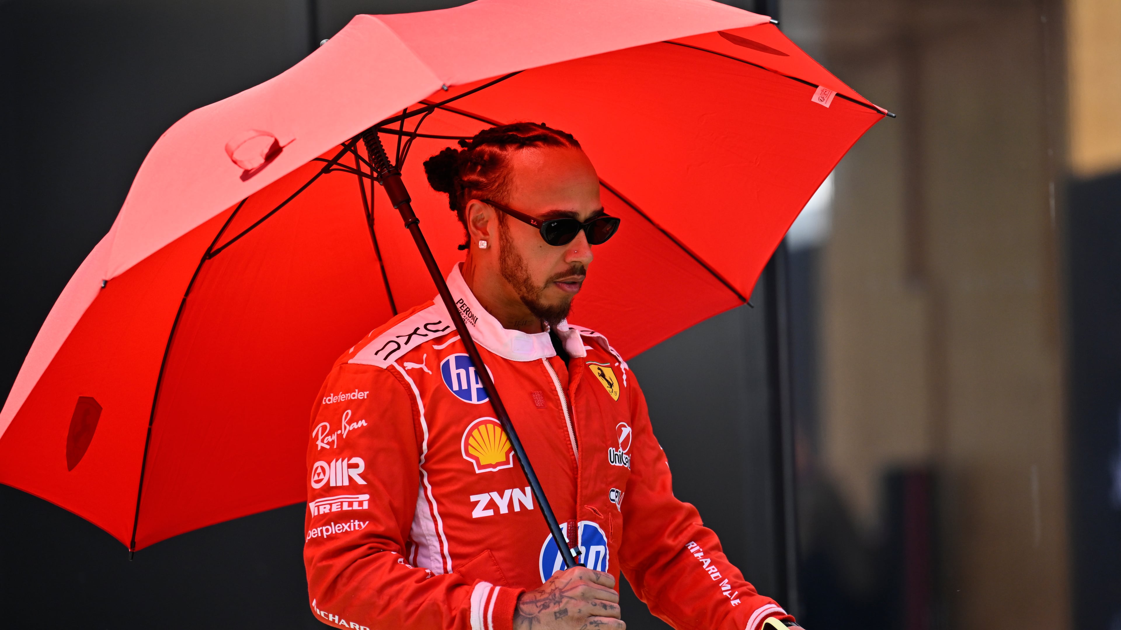 Ferrari driver Lewis Hamilton of Britain walks through the paddock ahead of the Austrian F1 Grand Prix, in Spielberg, Austria, Thursday, June 25, 2026. (AP Photo/Denes Erdos)