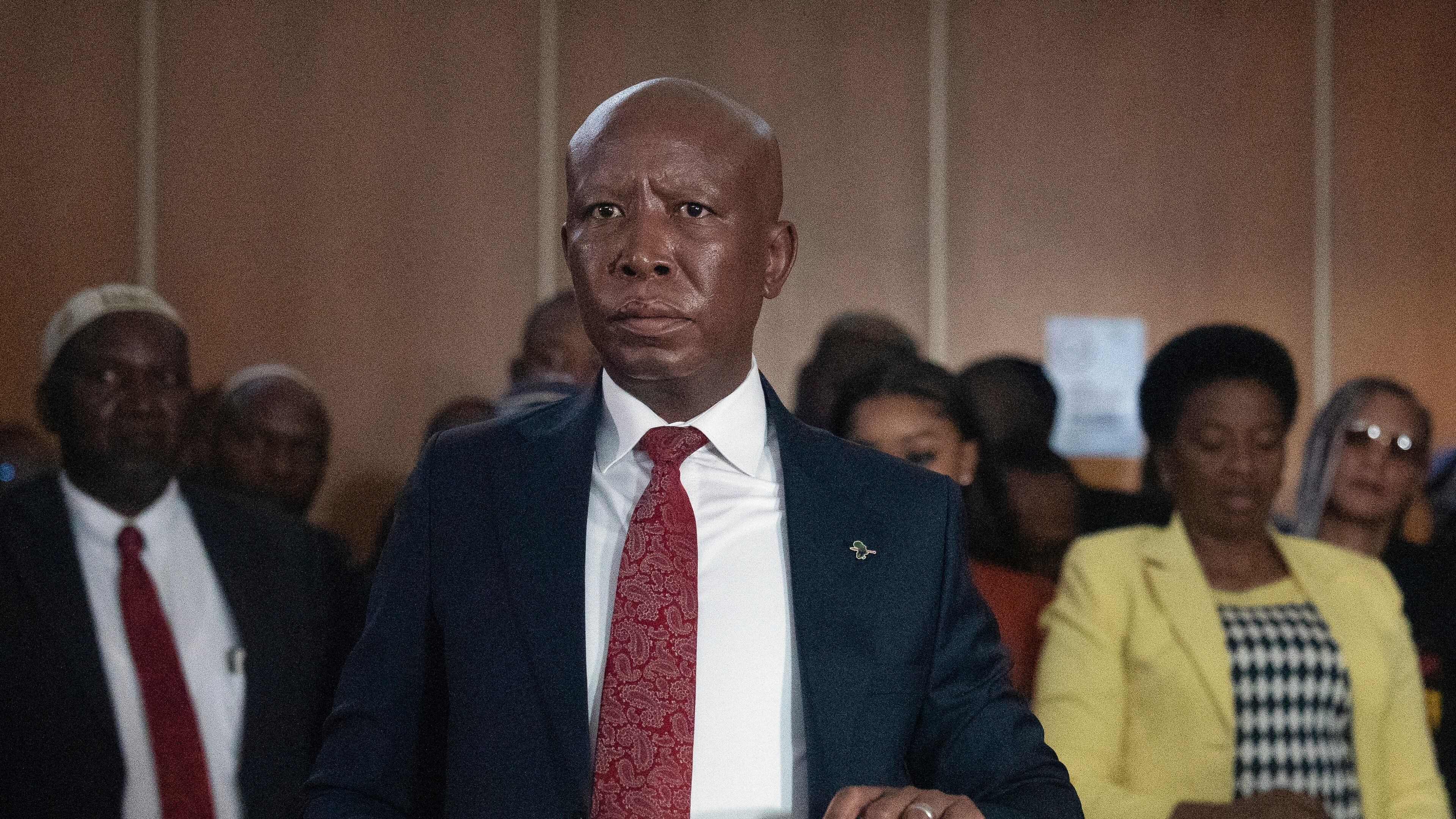 Julius Malema, Economic Freedom Fighters (EFF) party leader stands in the dock during his pre-sentencing hearing in court, East London, South Africa, Wednesday, April 15, 2026. (AP Photo/STR)