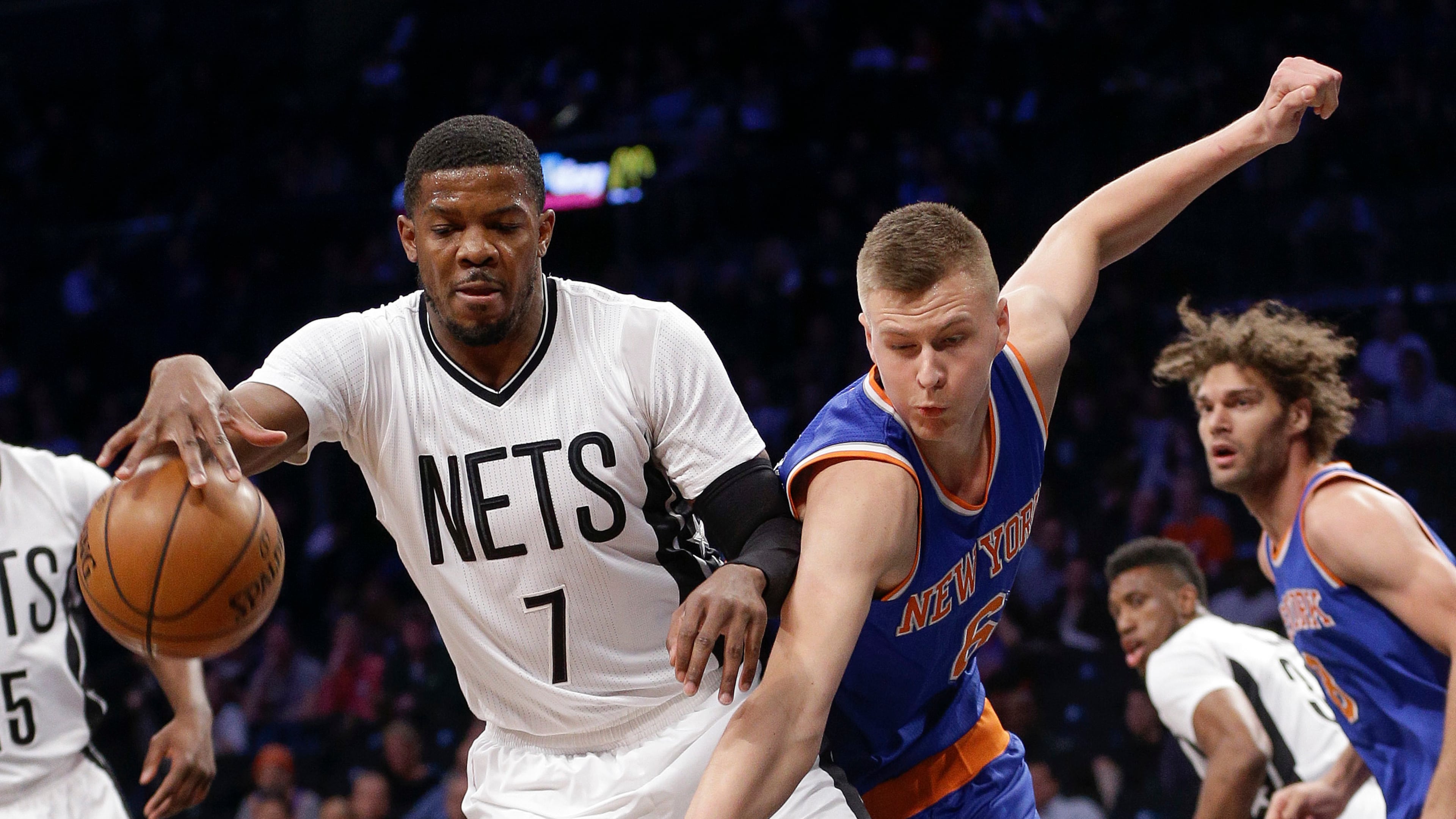 Brooklyn Nets forward Joe Johnson (7) pulls a rebound away from New York Knicks forward Kristaps Porzingis (6) during the first quarter of an NBA basketball game Friday, Feb. 19, 2016, in New York. (AP Photo/Julie Jacobson)