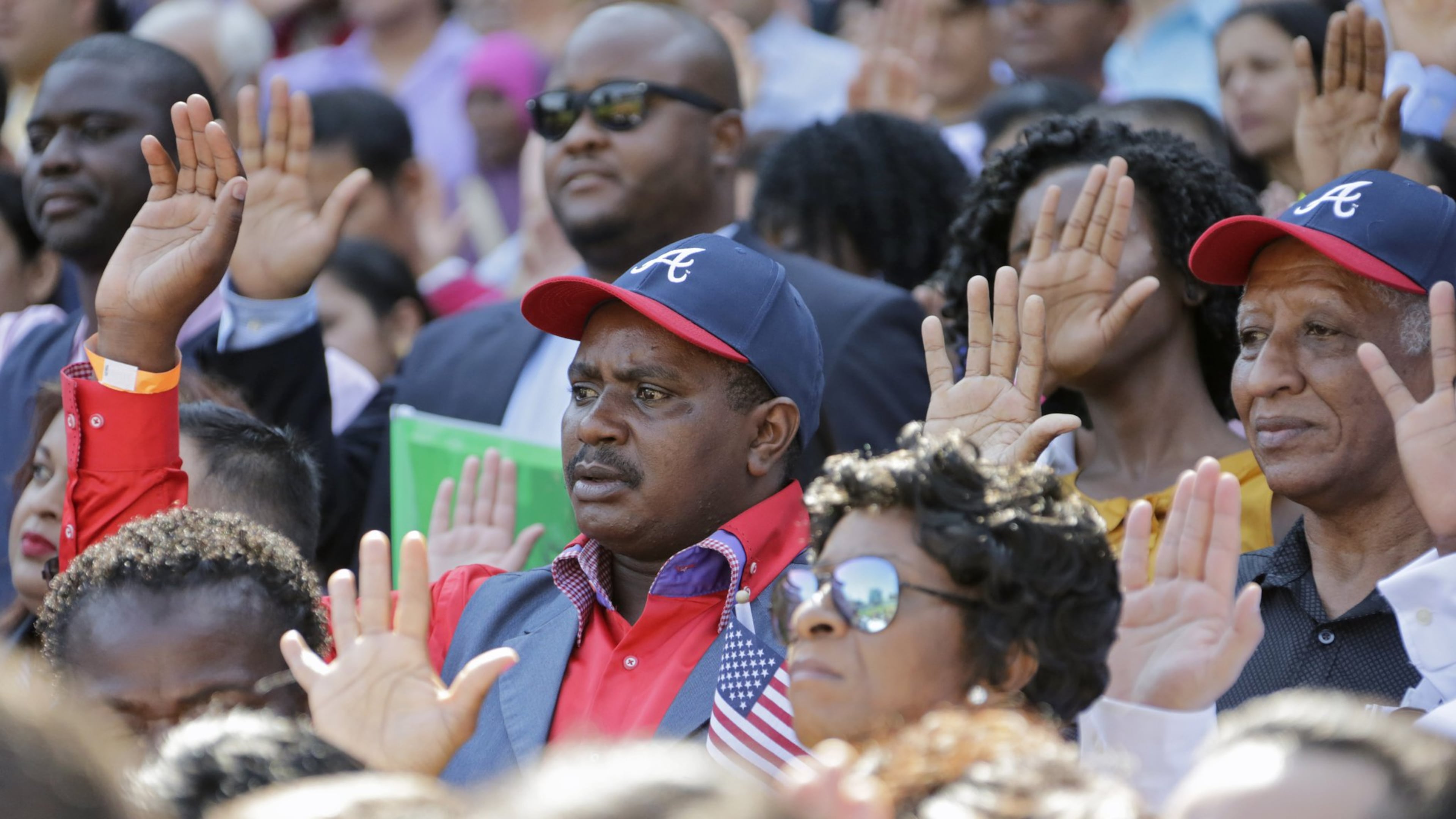 New citizens take their oath of allegiance at Turner Field. BOB ANDRES /BANDRES@AJC.COM