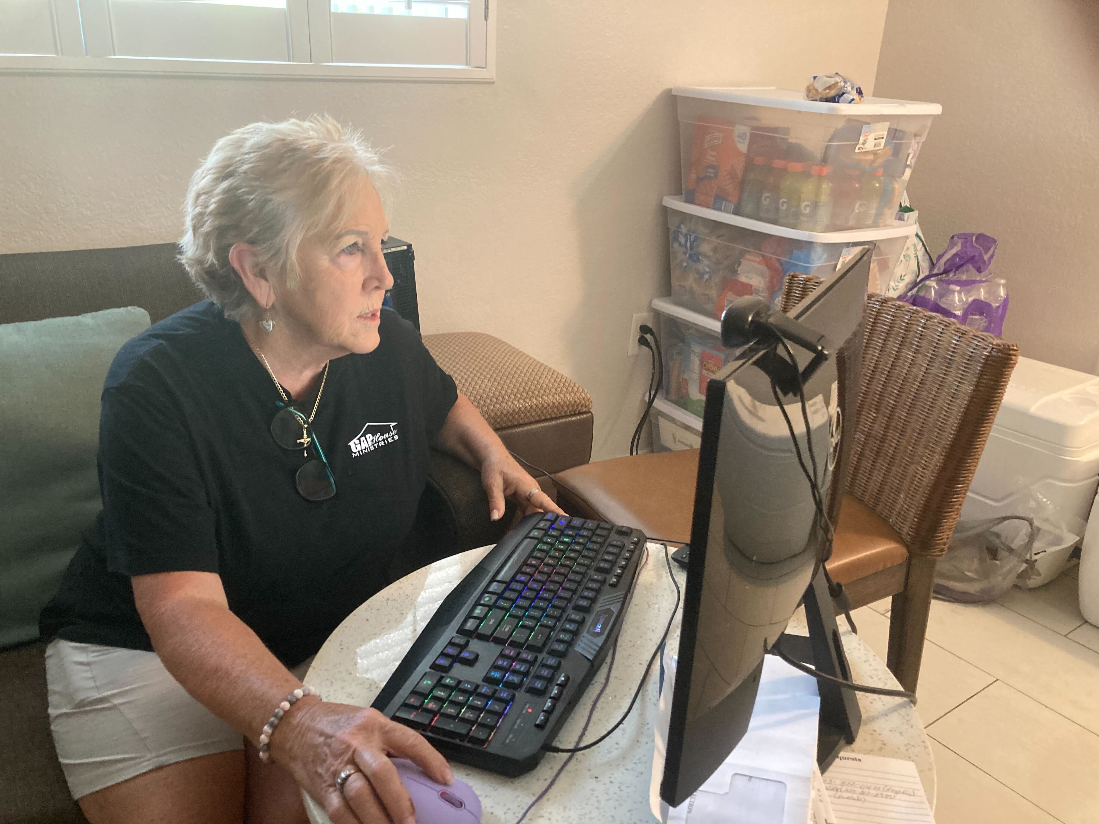 Regina Hunter, founder and executive director of GAP House Ministries, works in a makeshift office in Jekyll Island, Georgia on Thursday April 30, 2026. More than a dozen people evacuated the organization's premises in Brantley County on April 21 because of the Highway 82 wildfire. (Adam Van Brimmer/AJC)