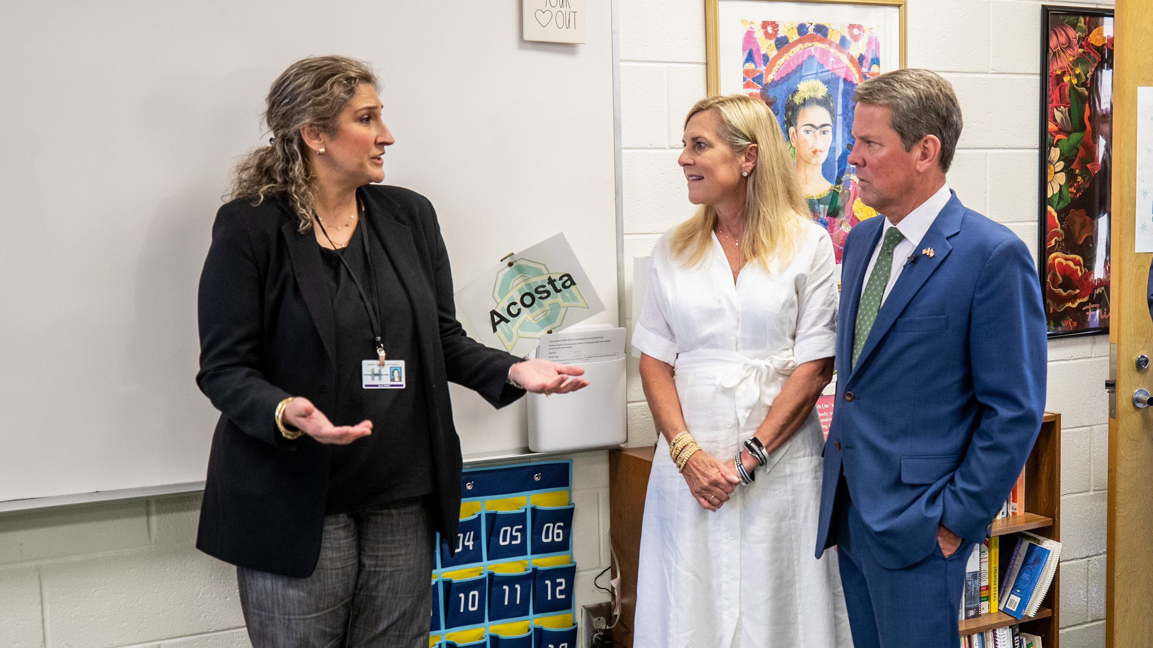 Ola High School's Dorcas Toledo-Acosta talks with Gov. Brian Kemp and first lady Marty Kemp after a press conference at Ola High School in Henry County on Friday, July 29, 2022. The governor announced $125 grants to help public school teachers pay for classroom supplies. (Steve Schaefer / steve.schaefer@ajc.com)