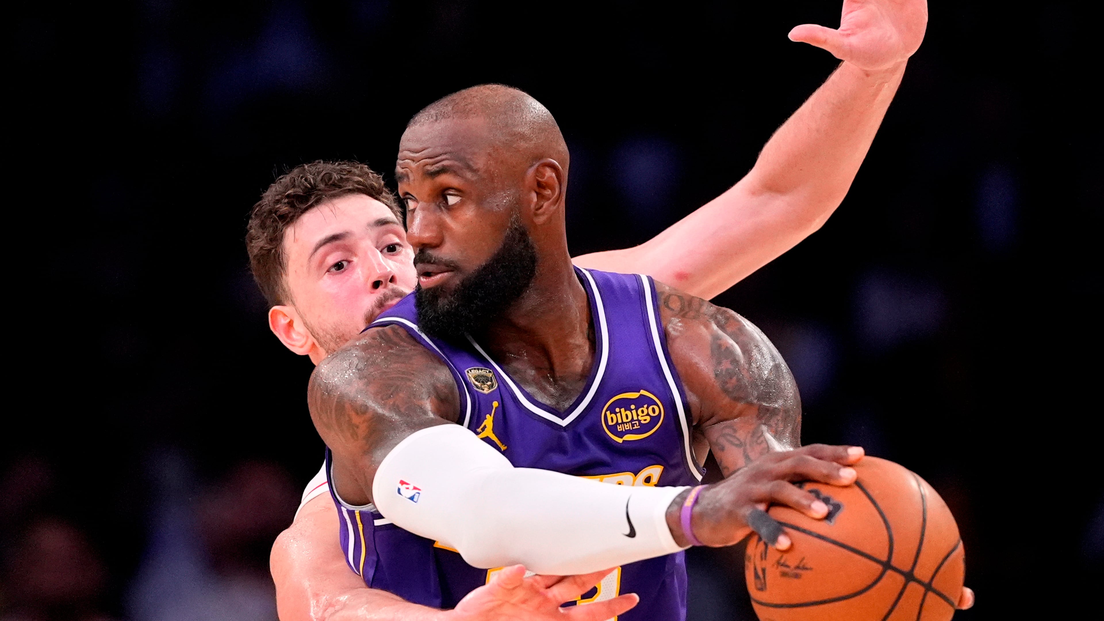 Houston Rockets center Alperen Sengun, left, reaches in on Los Angeles Lakers forward LeBron James during the second half in Game 5 of a first-round NBA playoffs basketball series Wednesday, April 29, 2026, in Los Angeles. (AP Photo/Mark J. Terrill)