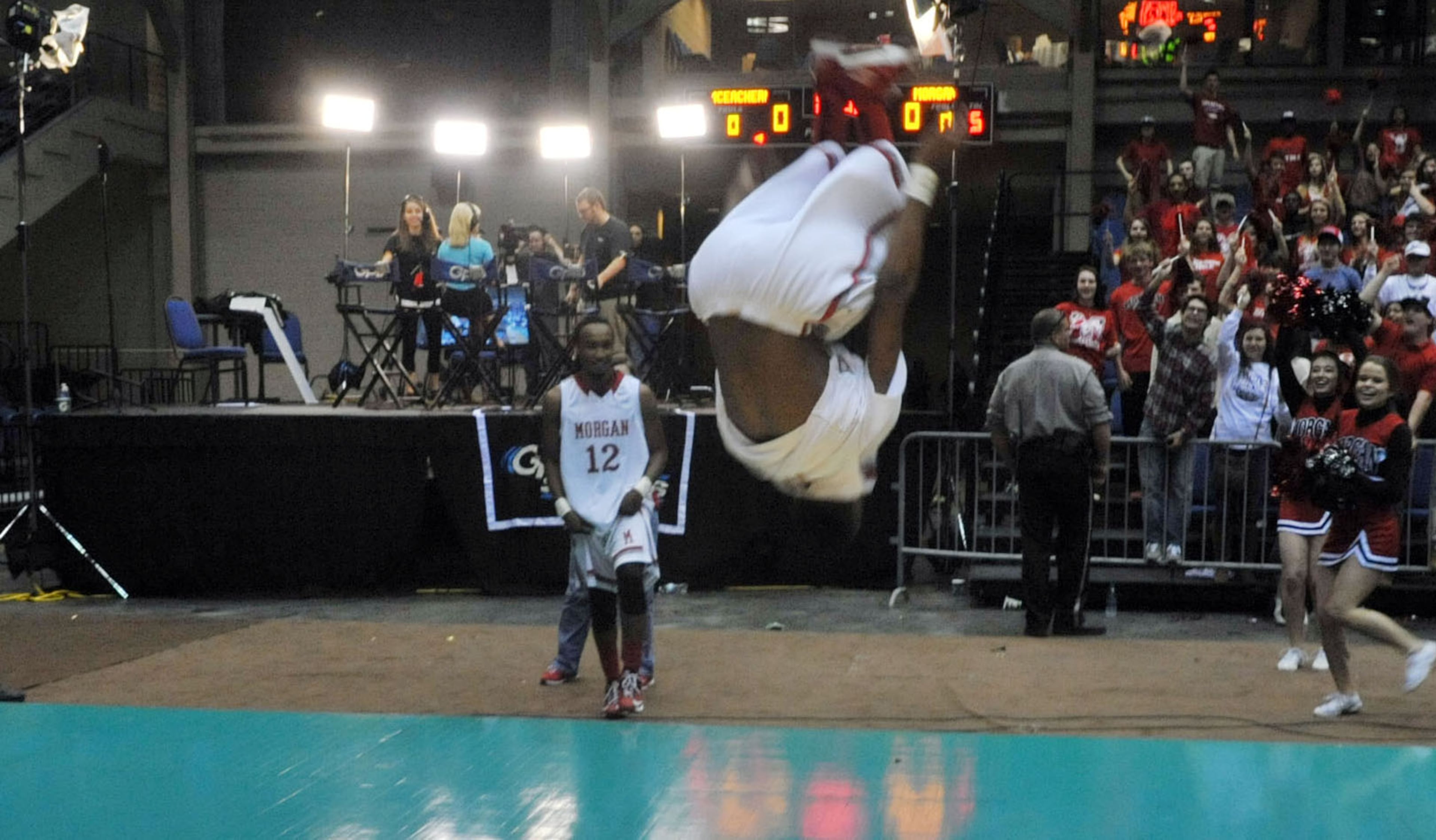 Morgan County Bulldogs TJ Starks #3 backflips as he celebrates the win. Coverage of the Class AAA boys basketball championship between the Buford Wolves and Morgan County Bulldogs at the Macon Coliseum Saturday, March 8, 2014. Morgan County won handily, beating the Buford Wolves 69-45.